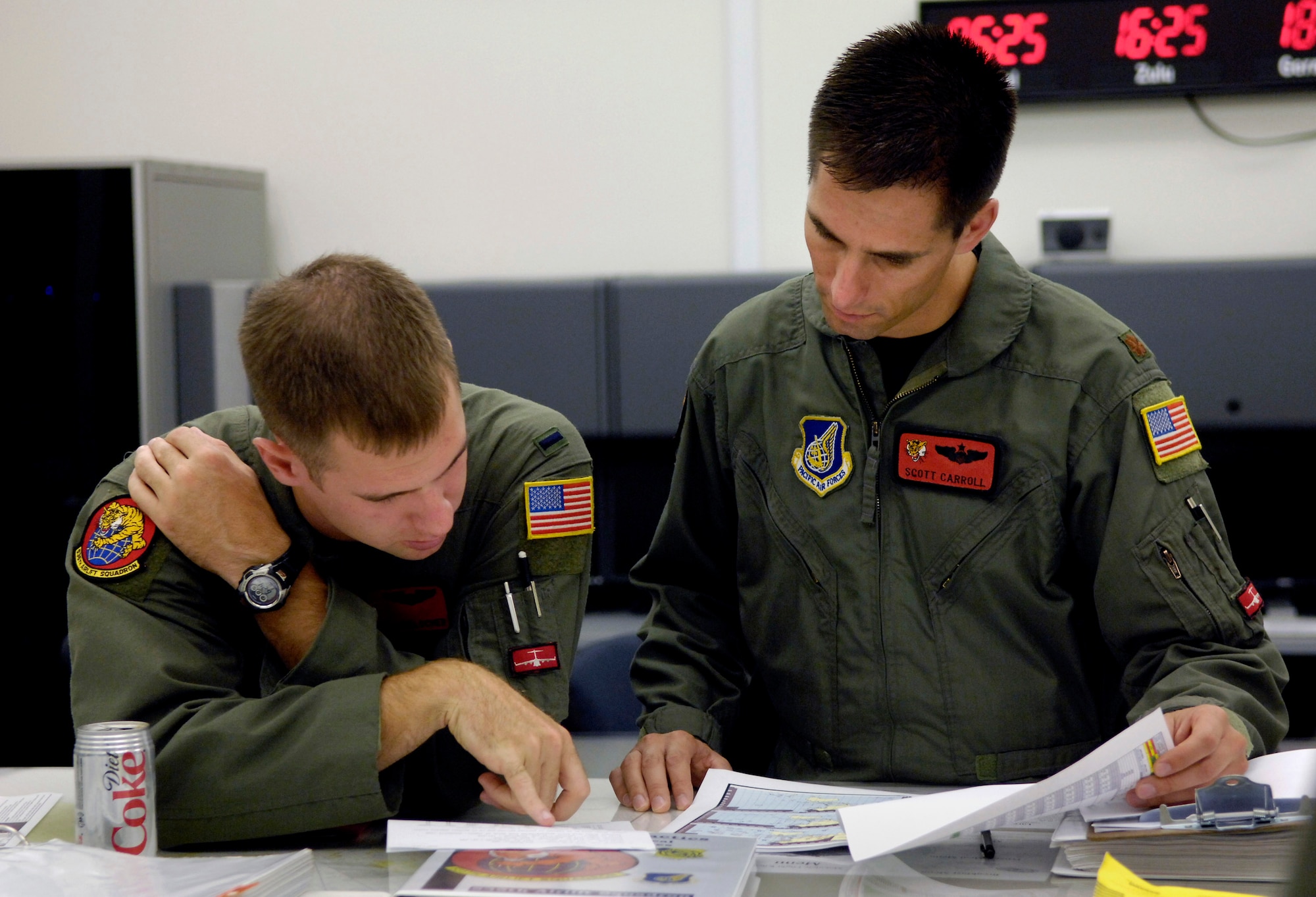 1st Lt. Jeff Hoelscher and Maj. Scott Carrol conduct an aircrew briefing prior to leaving for a four-ship airdrop training mission Aug. 13 at Hickam Air Force Base, Hawaii. The Airmen, pilots from the 535th Airlift Squadron, are conducting a four-ship, multi-element airdrop training mission to maintain currency and proficiency. (U.S. Air Force photo/Tech. Sgt. Shane A. Cuomo) 
