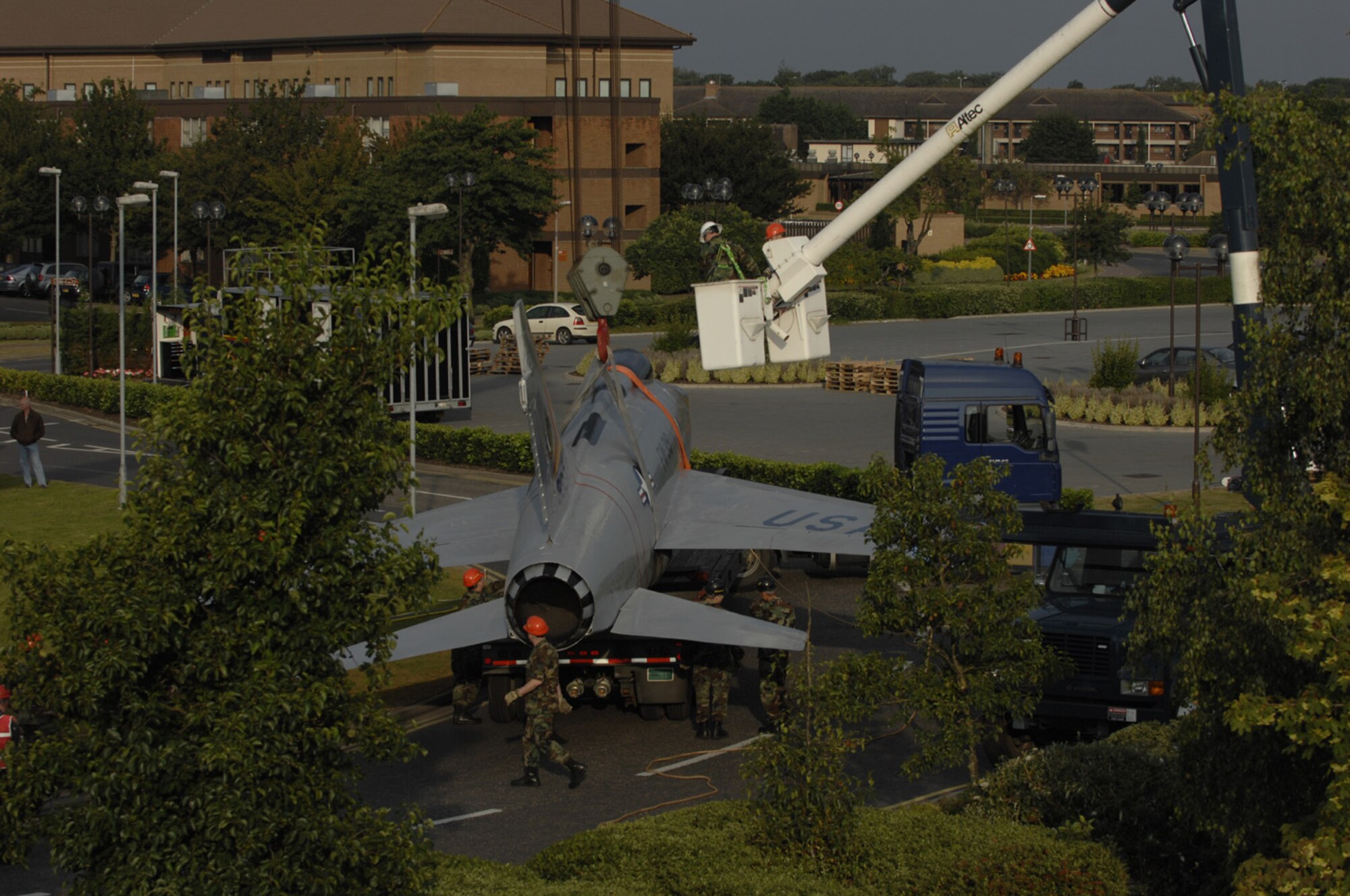 Airmen from RAF Lakenheath's 48th Equipment Maintenance, 48th Civil Engineering Squadrons and several other base organizations work to secure the base's display F-100 to a crane to be placed back on display by Gate 1 Aug 11. (U.S. Air Force photo by Airman 1st Class Jessica Snow)
