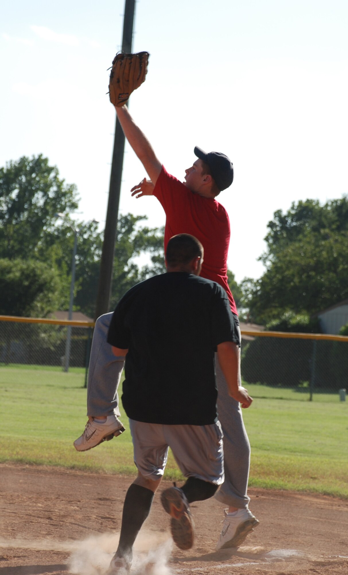 Justin McCoy, 361st Training Squadron Hellcats, jumps to make a catch at the Airmen in Training Softball Championships Aug. 8. The Hellcats won, 10-3. (U.S. Air Force photo/Airman 1st Class Jacob Corbin)