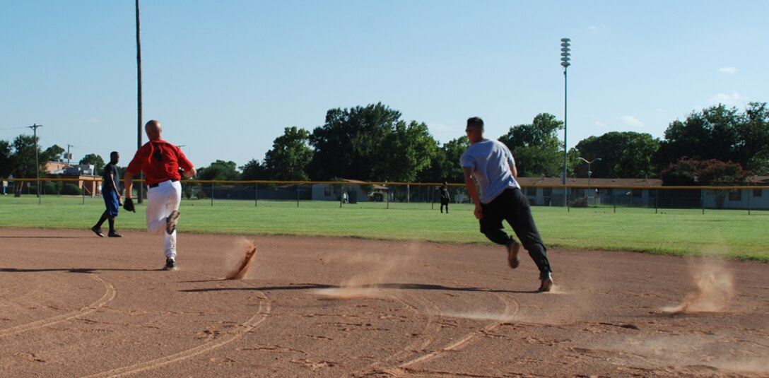 John Mcinnes (left) and Rob Sellers run the bases at the Airmen in Training Softball Championships Aug. 8. The Hellcats won, 10-3. (U.S. Air Force photo/Airman 1st Class Jacob Corbin)