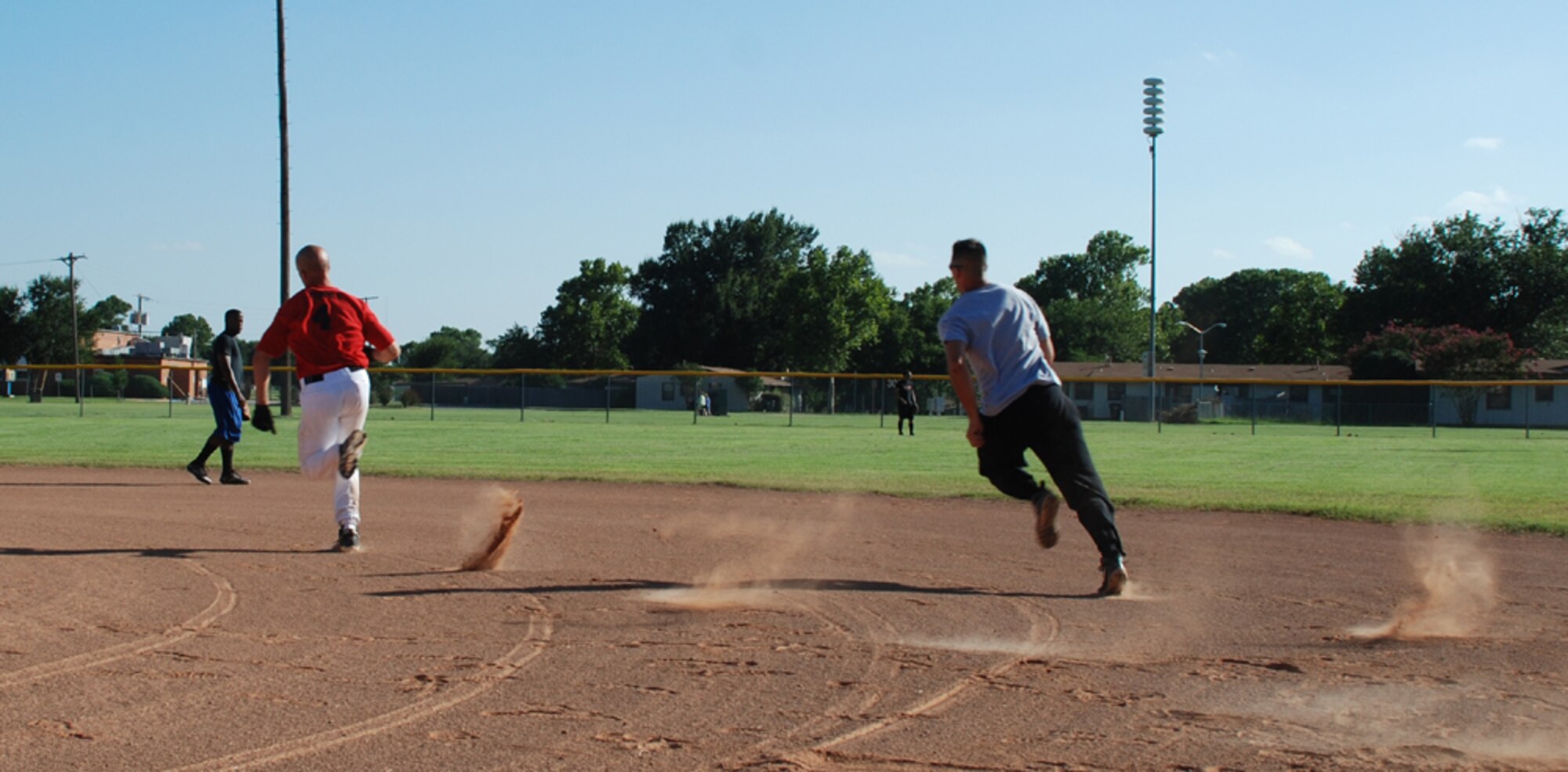 John Mcinnes (left) and Rob Sellers run the bases at the Airmen in Training Softball Championships Aug. 8. The Hellcats won, 10-3. (U.S. Air Force photo/Airman 1st Class Jacob Corbin)
