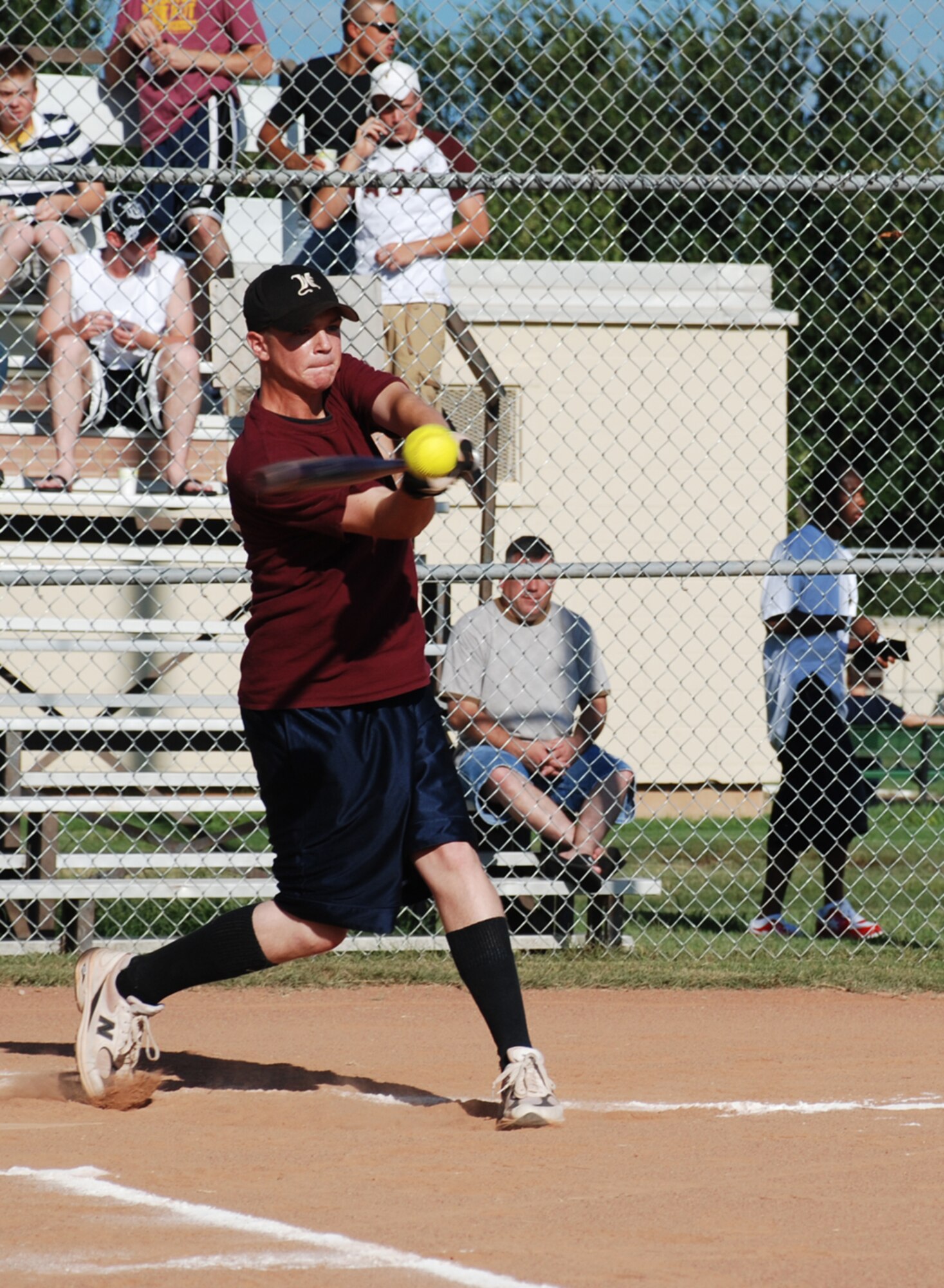 Troy White, 361st Training Squadron Hellcats,slams the ball at the Airmen in Training Softball Championships Aug. 8. The Hellcats won, 10-3. (U.S. Air Force photo/Airman 1st Class Jacob Corbin)