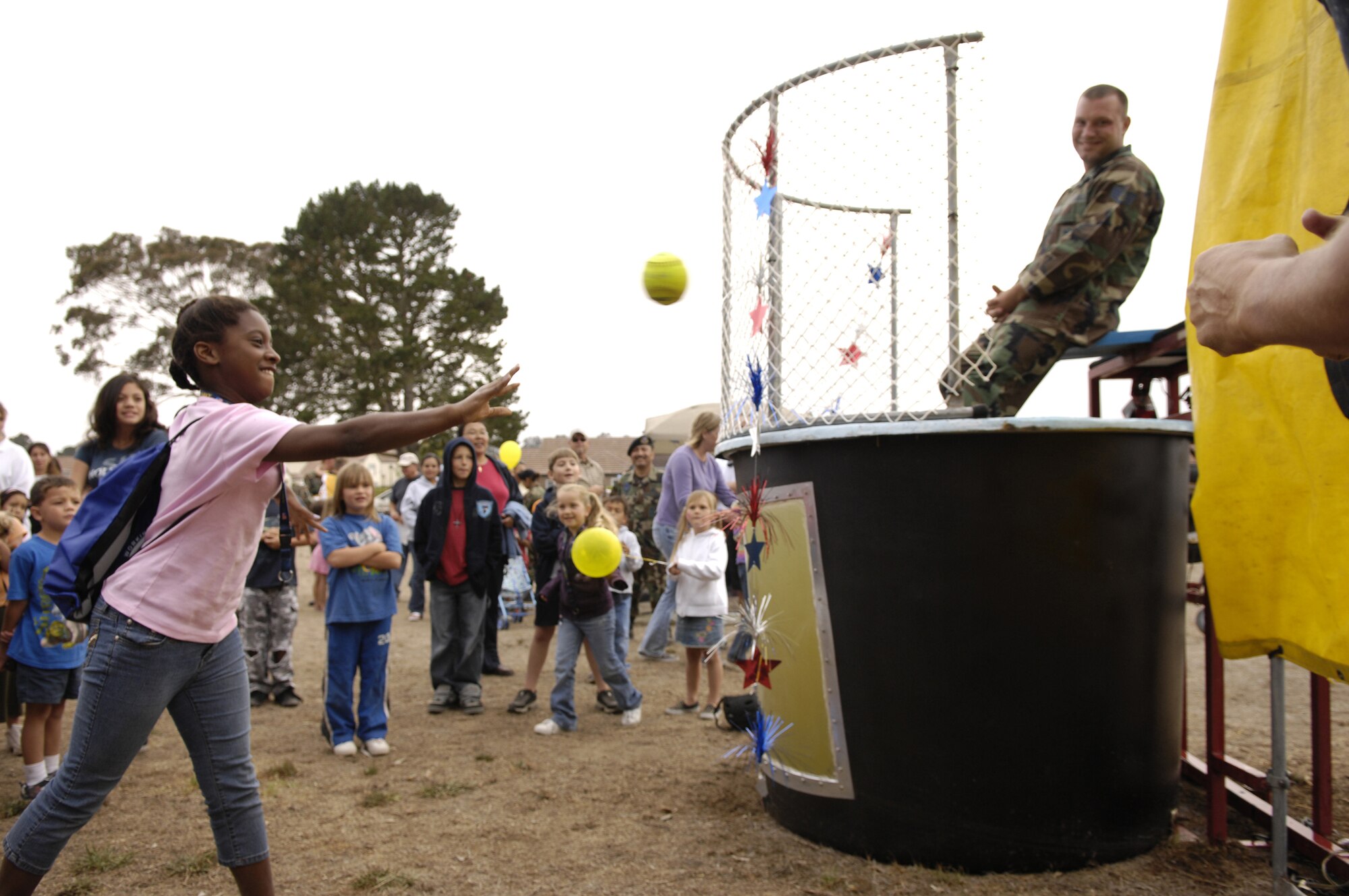 VANDENBERG AIR FORCE BASE, Calif. -- Staff Sgt. Sean Yargus, 30th Security Forces Squadron, prepares to be dunked as a young girl pitches a ball at the dunking booth during the National Night Out on Aug.10.  National Night Out is an event designed to increase children's awareness of safety. (U.S. Air Force photo/Airman Jonathan Olds)