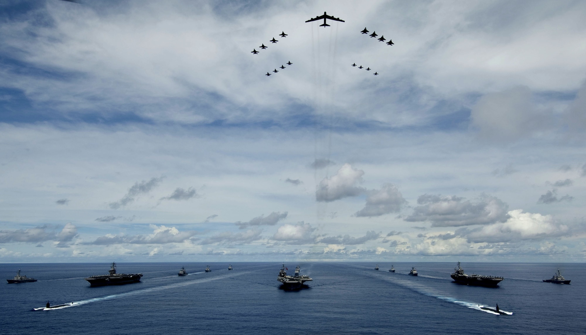 A B-52 Stratofortress leads a formation of Air Force and Navy F-16 Fighting Falcons, F-15 Eagles, and F-18 Hornetst over the USS Kitty Hawk, USS Nimitz and USS John C. Stennis Strike Groups during Exercise Valiant Shield exercise Aug.14 in the Pacific. The forces participated in Valiant Shield, the largest joint exercise in the Pacific this year. Held in the Guam operating area, the exercise includes 30 ships, more than 280 aircraft and more than 20,000 servicemembers from the Navy, Air Force, Marine Corps, and Coast Guard. (U.S. Navy photo/Petty Officer 2nd Class Jarod Hodge) 
