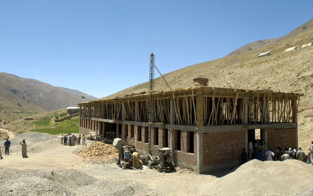 Members of the Panjshir Provincial Reconstruction Team check on the progress of a school construction project, Aug. 4, 2007. The school will accommodate children from several villages in the province. The children are currently attending classes in makeshift tents overlooking the construction site. The project is one of several being monitored by the PRT in the Paryan district of Panjshir province, Afghanistan. 