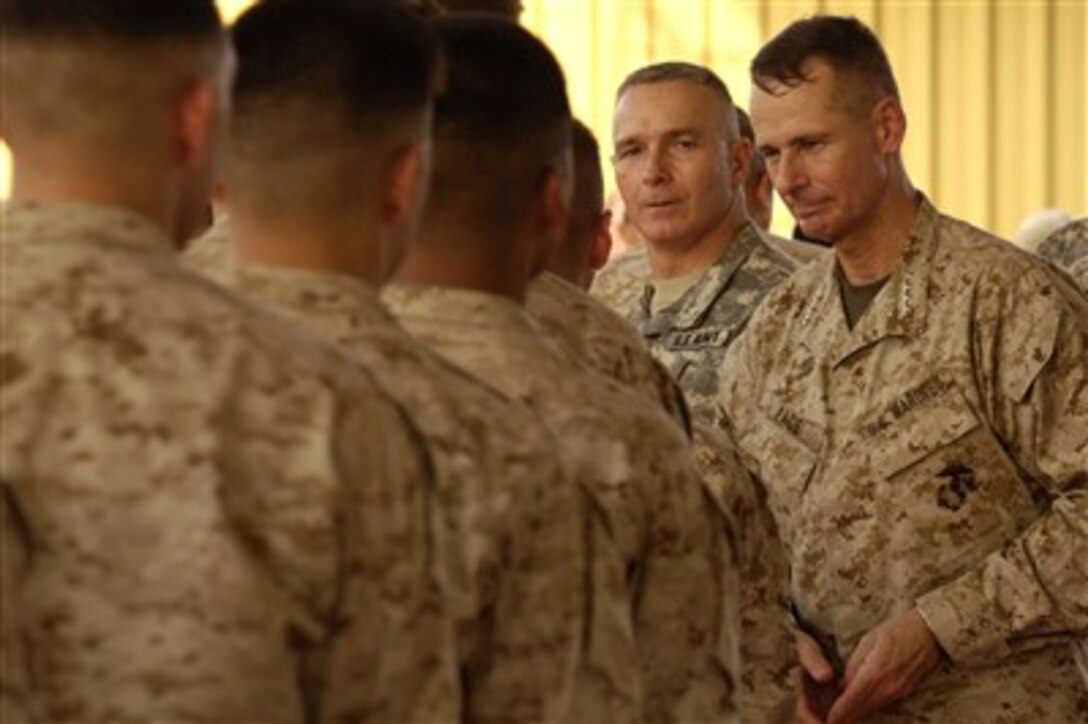 Marines from the 6th Provisional Security Company stand in line to shake hands and thank Chairman of the Joint Chiefs of Staff Gen. Peter Pace (right), U.S. Marine Corps, for visiting Camp Lemonier, Djibouti, on Aug. 14, 2007.  Pace and Senior Enlisted Advisor to the Chairman of the Joint Chiefs of Staff Command Sgt. Maj. William Gainey (2nd from right) conducted a town hall meeting with service members deployed to Combined Joint Task Force - Horn of Africa.  