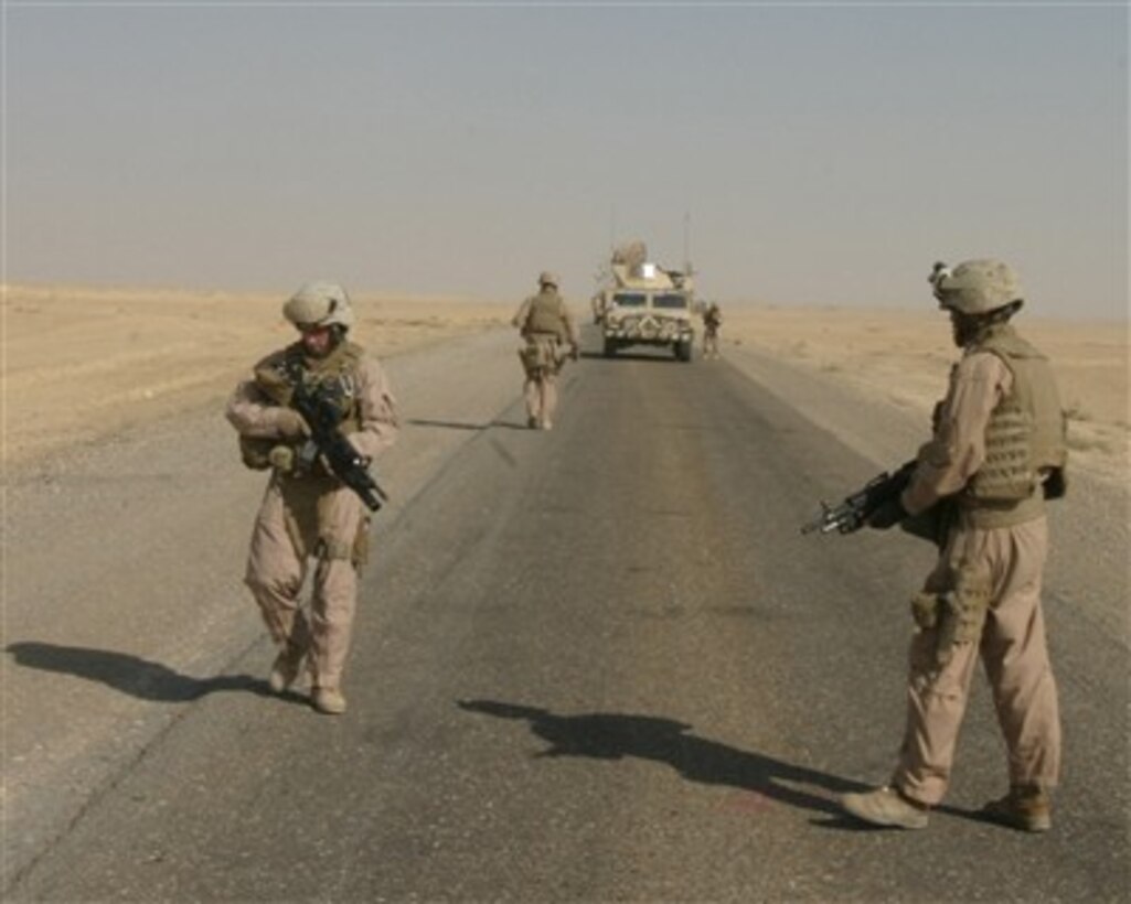 U.S. Marines inspect and clear a road for possible improvised explosive devices during a sweep south of Al Asad Air Base, on Iraq, on Aug. 7, 2007.  The Marines are attached to Marine Wing Support Squadron 271.  