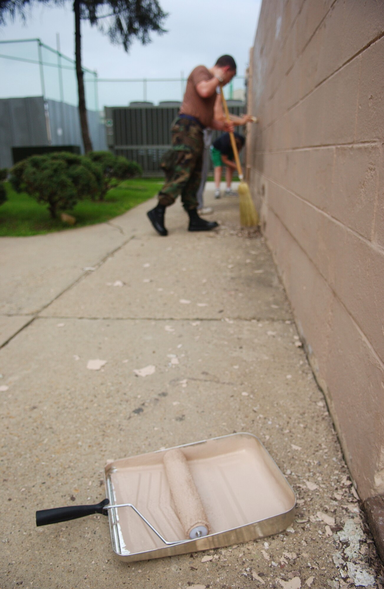 OSAN AIR BASE, Republic of Korea -- Airman 1st Class Kyle Van Vickle, 51st
Mission Support Squadron, sweeps up the chipped paint around the building he
works at, so that the painters can come in and finish the job on Aug. 15.
Taking the time to clean up around each office or area not only beautifies
the squadron and base, but also raises morale.  (U.S. Air Force Photo by
Airman 1st Class Chad Strohmeyer)