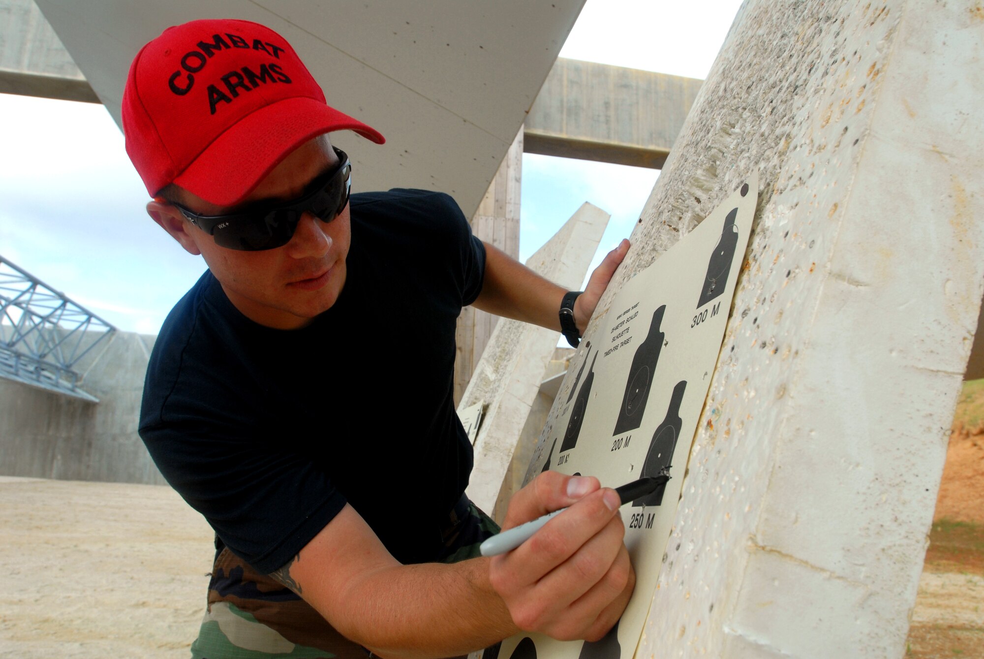 Staff Sgt. Lars Schied marks the qualifying shots during the M4 Tactical Qualification Course at Kadena Air Base, Japan, Aug. 7, 2007. The course ensures that every security forces member stay qualified with the M4 rifle.  Sergeant Schied is a 18th Security Forces Squadron combat arms instructor. (U.S. Air Force photo/Senior Airman Darnell T. Cannady)