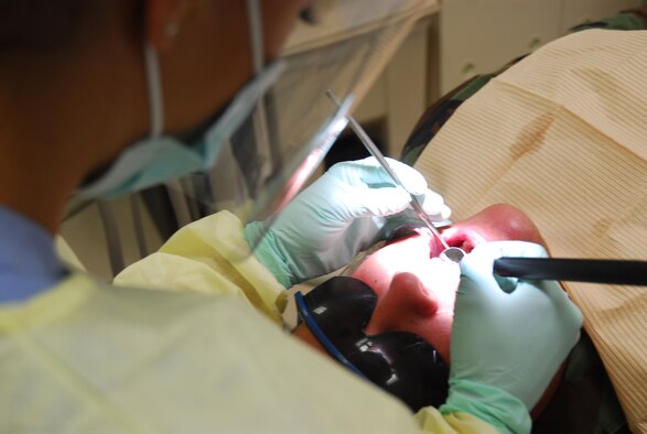 Senior Airman Kelly Hargraves performs a dental prophylaxis on Staff Sgt. Robert Keegan at Kadena Air Base, Japan, August 6, 2007. The prophylaxis is used not only to clean teeth, but also to evaluate the oral cavity for any other problems that might be present. The dental clinic averages  200 appointments a day for military members and their family at general dentistry as well as orthodontics, pediatric dentistry, periodontics, prosthodontics, endodontrics, and oral surgery. Airman Hargraves is assigned to the 18th Dental Squadron and Sergeant Keegan is with 18th Equipment Maintenance Squadron. (U. S. Air Force photo by A1C Sheila deVera)