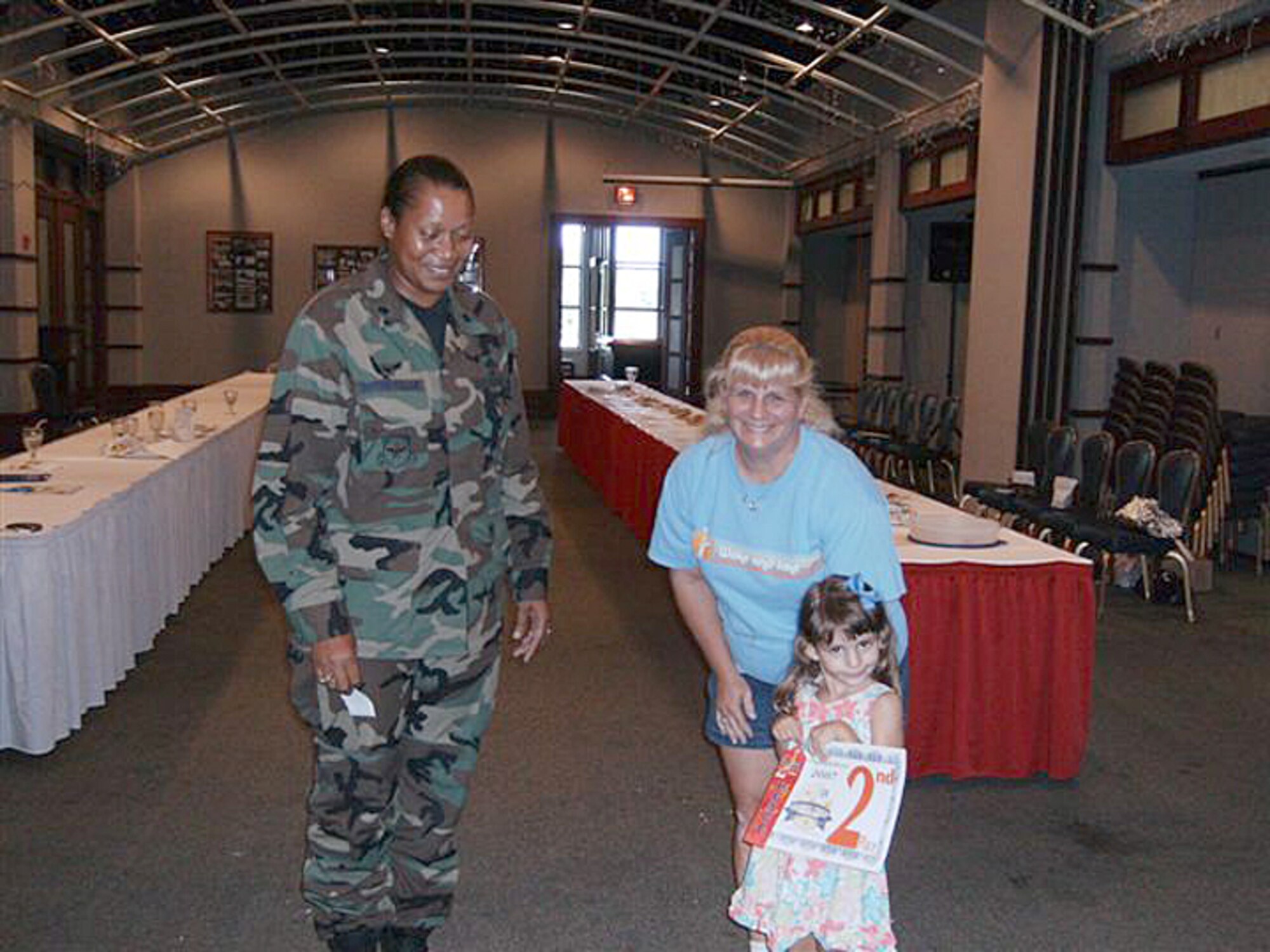 MCCONNELL AIR FORCE BASE, Kan. – Lt. Col. Sonya Collins, 22nd Services  Squadron commander presents a second place certificate to Alyssa Casa, 4, and her mother Wendi, McConnell family members, for her cookies entered in the Colossal Cookie Challenge, Aug. 9 at the Robert J. Dole Center. The contest was hosted by the 22nd Services Squadron and had 18 entries. Contestants’ entries were judged on taste, appearance and creativity. (photo by Amanda Pozehl) 