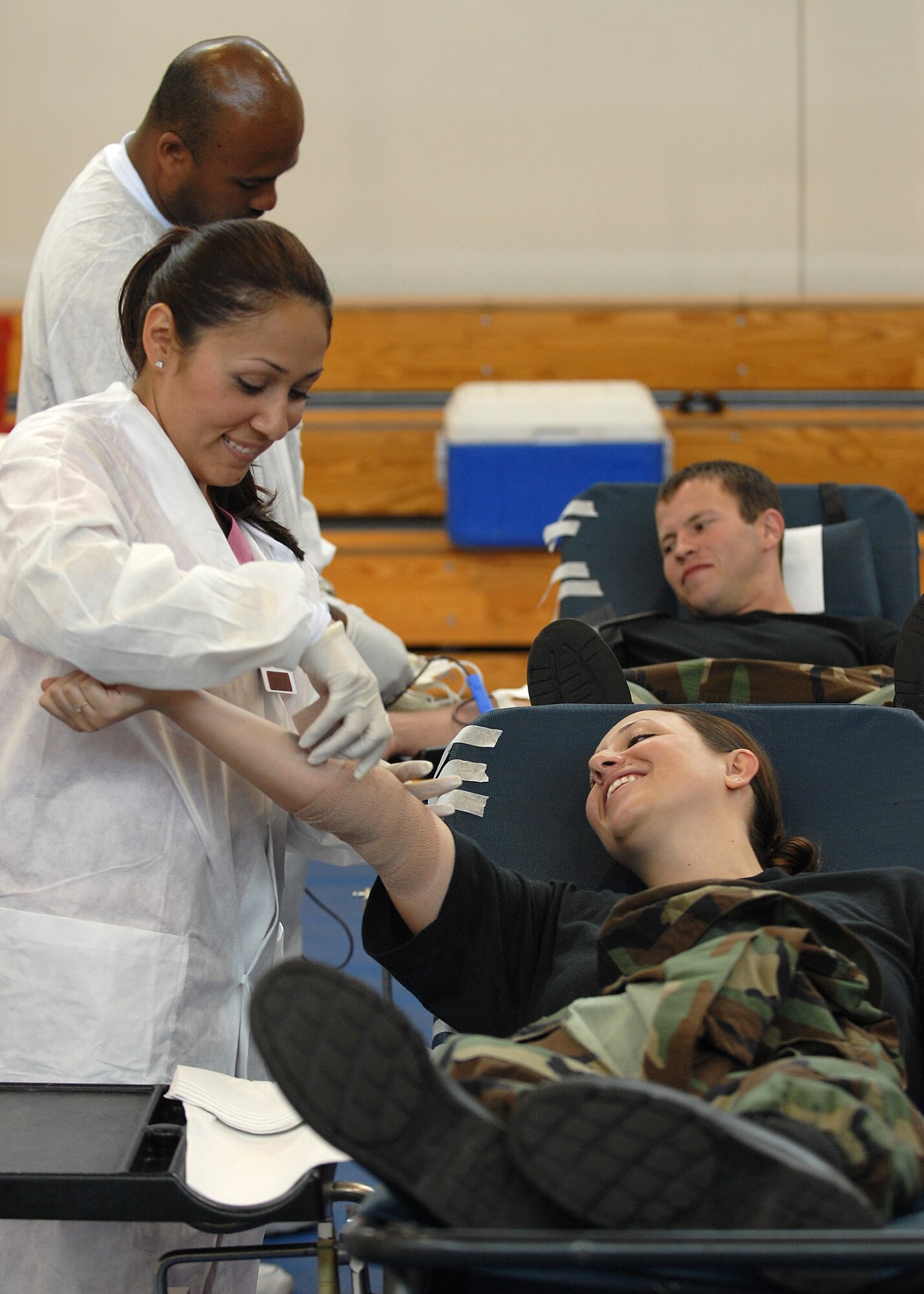 Staff Sgt. Amy Snell and First Lieutenant Brett Hadley, both from the 61st Communications Squadron, Los Angeles Air Force Base, CA, donate blood with the help from two American Red Cross workers during a base wide blood drive Aug 15, 2007. (Photo by Stephen Schester)