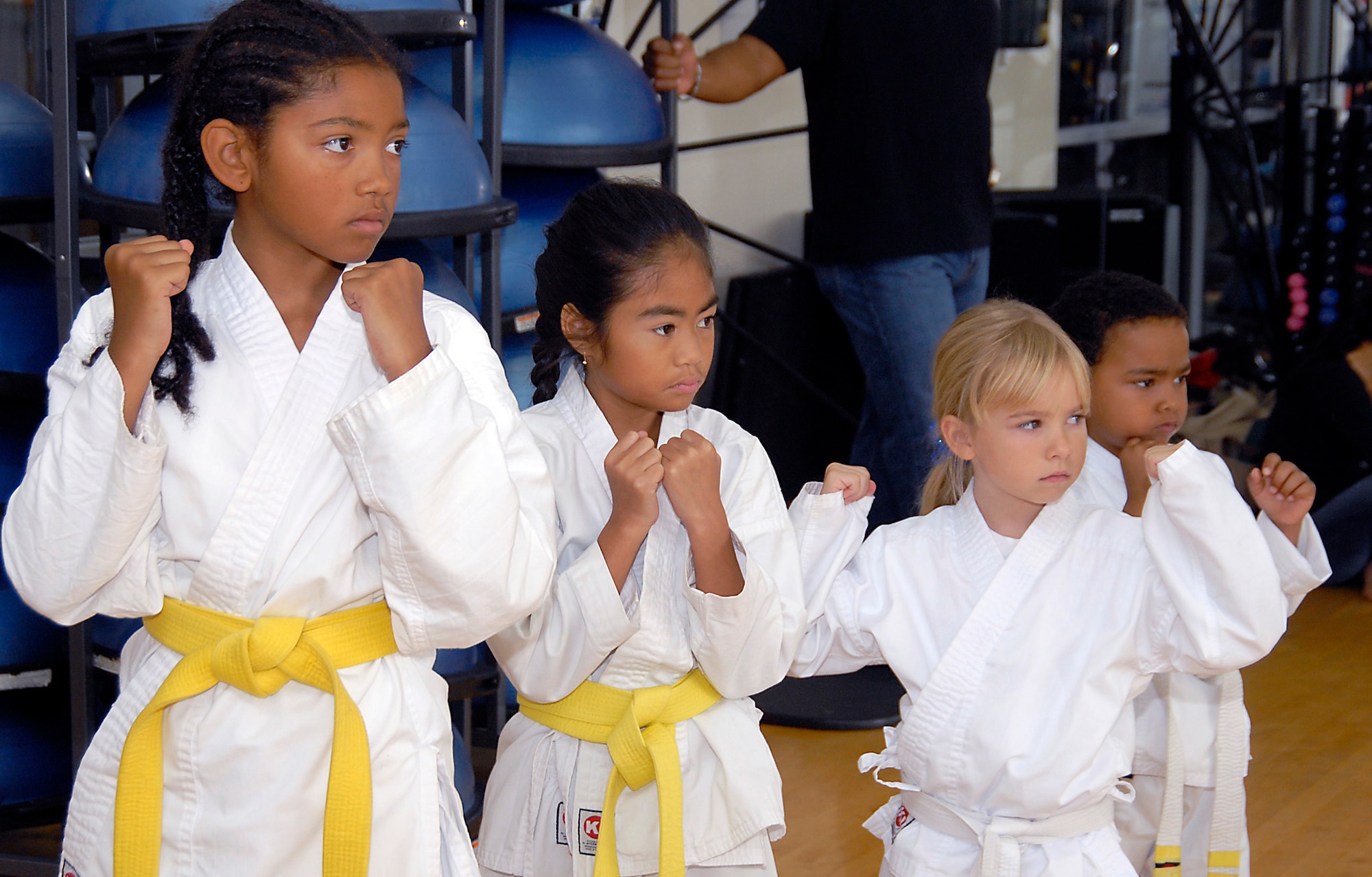 Cambria Green, 9, Kimberly Sleeis, 7, Avianna Raupach, 6, and Quentin Evans, 4, demonstrate their stance. Martial Arts students and fans gathered at the Los Angeles AFB Fitness Center for a demo of the Cory Jitsu / Comba-tai discipline, Aug. 11.  (Photo by Joe Juarez)