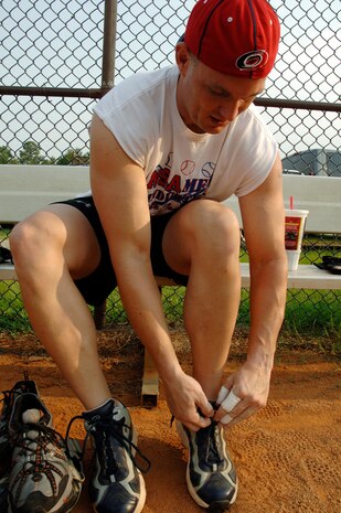 Eric Erbaugh, 437 OSS, ties his shoes while preparing for final practice before the tournament. (U.S. Air Force Photo/Staff Sgt. April Quintanilla)