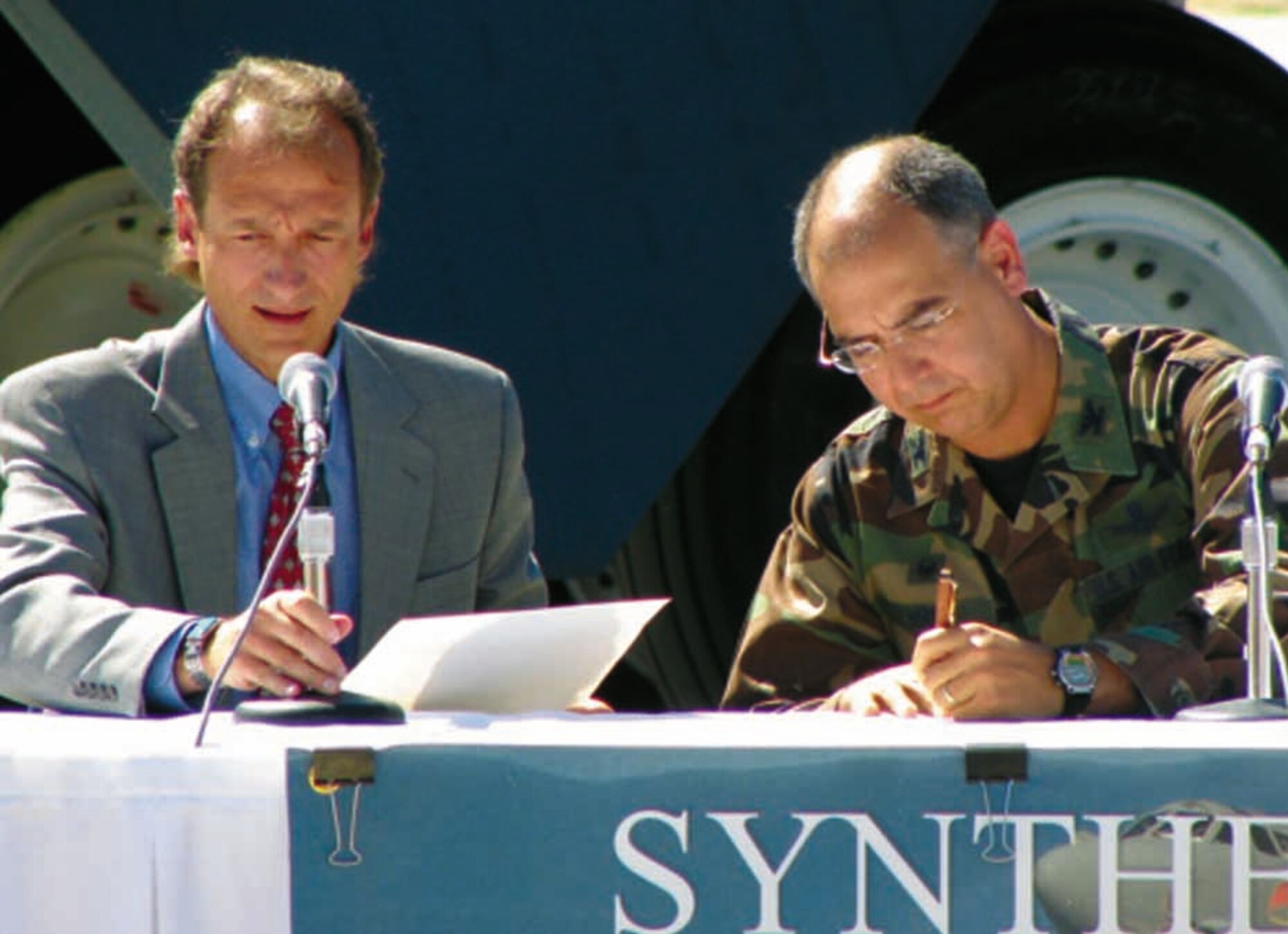 Col. Michael Hirka, 327th Aircraft Sustainment Group commander, signs the certificate certifying Fischer-Tropsch synthetic fuel blends for use in the B-52H Stratofortress as Jerold Smith, chief engineer with the 327th ASG, reads the official document. Air Force photo