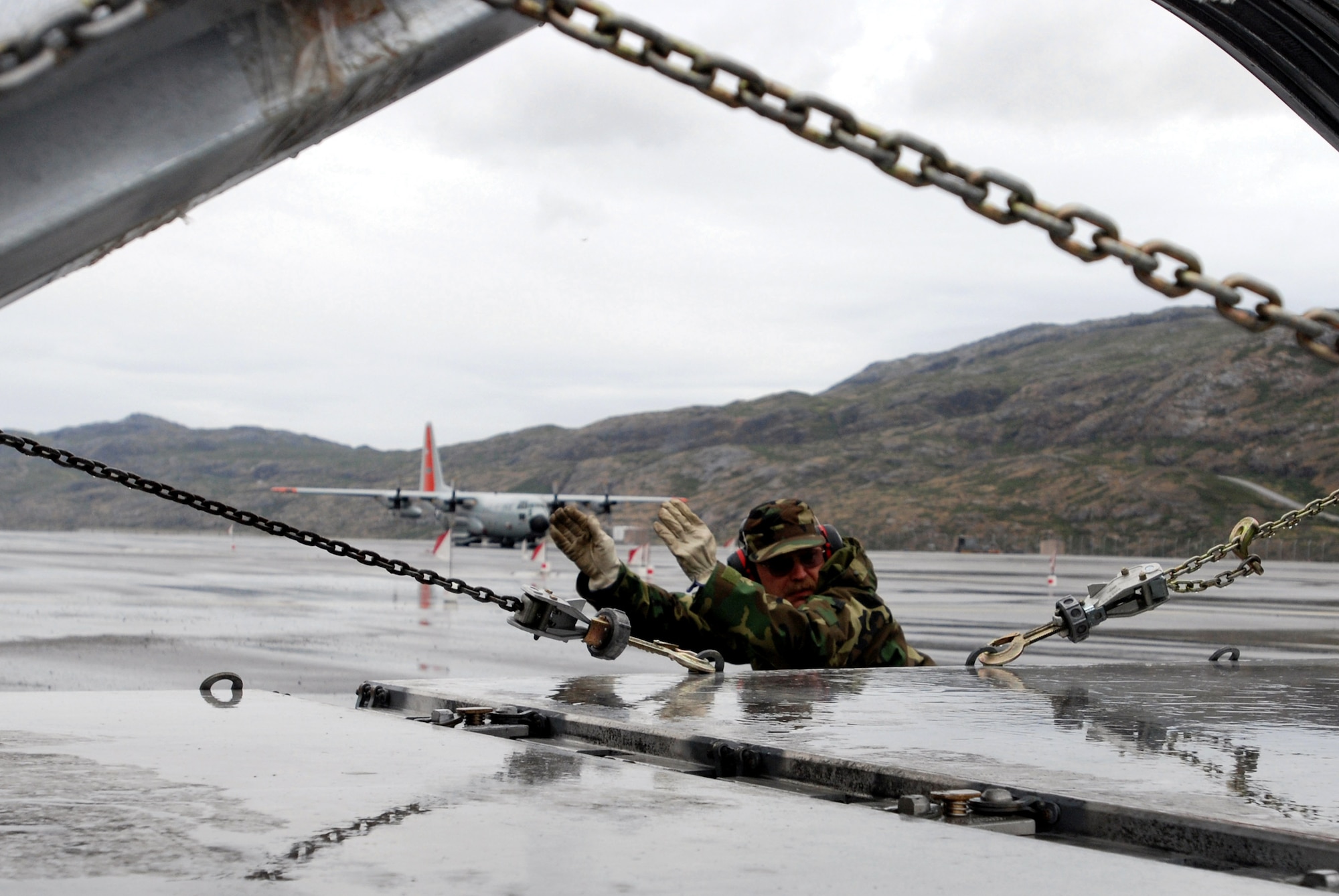 Master Sgt. Ray Boyea from the New York Air National Guard's 109th Airlift Wing directs cargo onto an LC-130 Hercules July 26 on the flight line at Kangerlussuaq Airport, Greenland.  The wing's gray and orange "skibirds" are the world's largest ski-equipped cargo aircraft. (U.S. Air Force photo/Tech. Sgt. Mike R. Smith)
