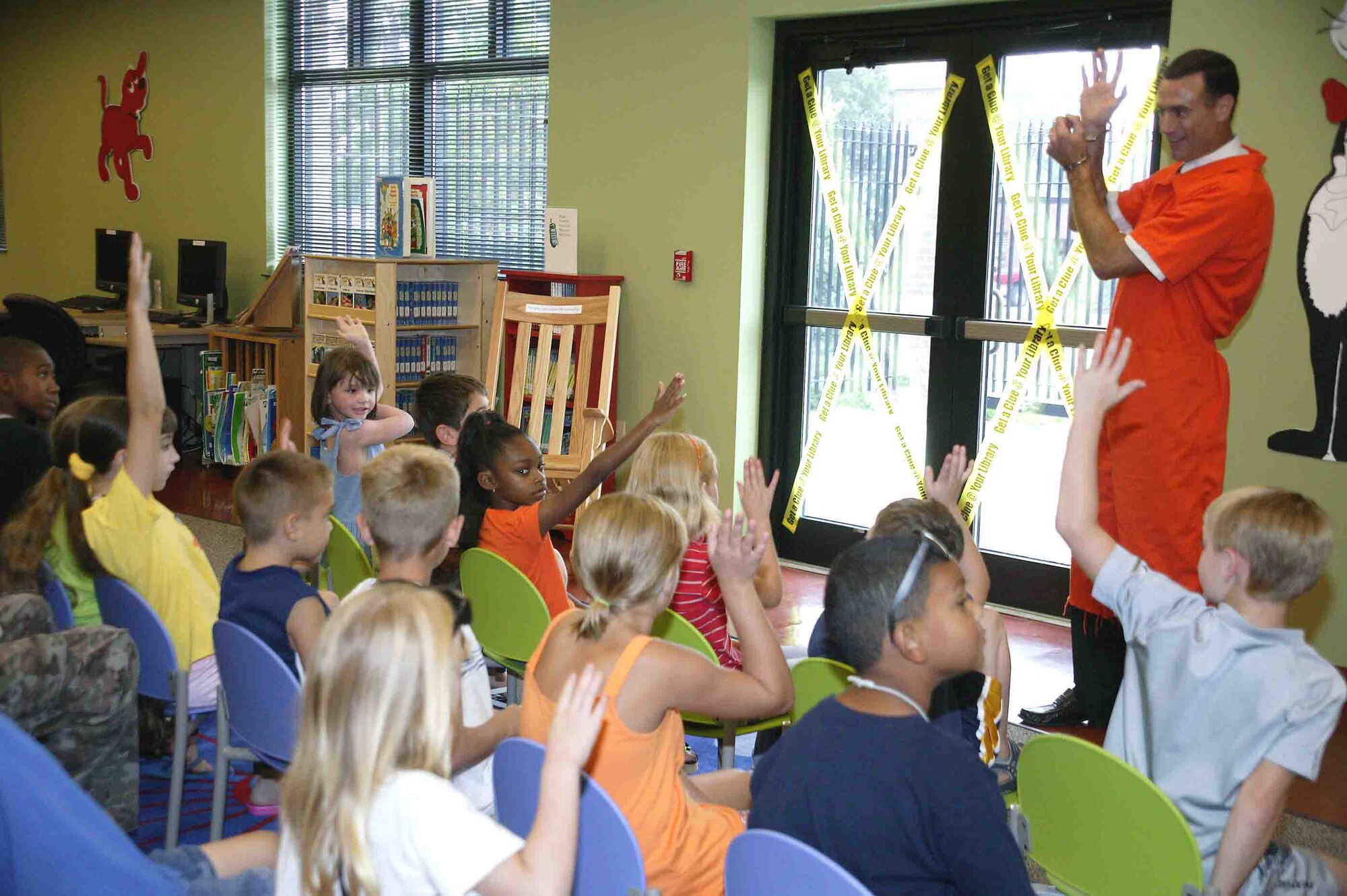 SHAW AIR FORCE BASE, S.C. -- Mr. Lee McGranagham, 20th Security Forces Squadron personnel security specialist, speaks to children about detective work, mysteries and clues during the "Get a Clue at your local library" reading program graduation Aug. 15. The children received certificates and medals for their reading accomplishments throughout the summer. (U.S. Air Force photo/Senior Airman John Gordinier)