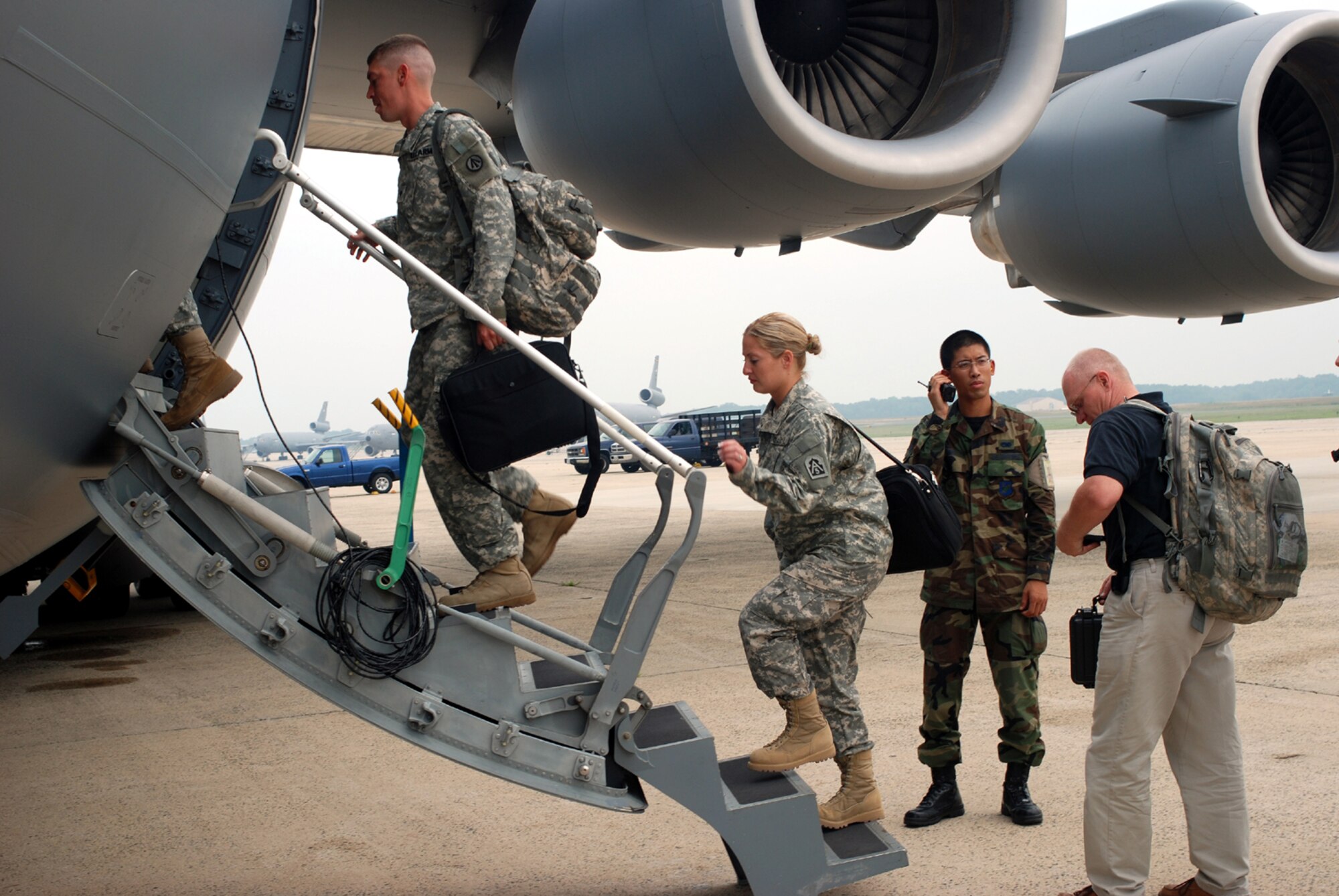 Joint Assessment Team members board their aircraft as they prepare to deploy to Puerto Rico in response to "Hurricane Dean" Aug. 16 here. The 16-member team will assess the area and decide how many personnel and assests are needed in the field.
