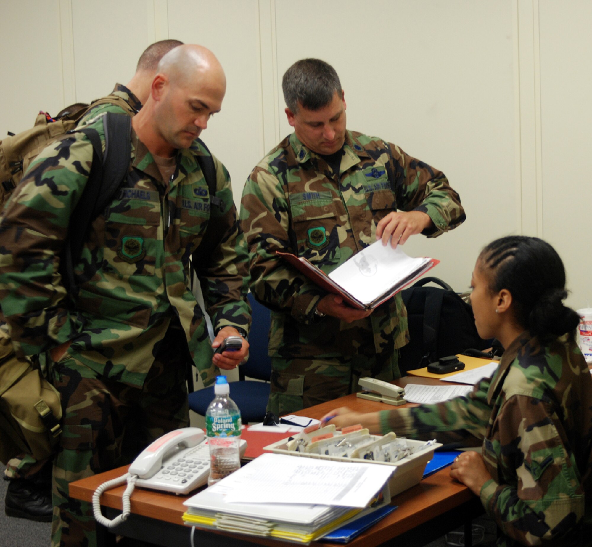 Left to right, 1st Lt. Jay Michaels, 818th Global Mobility Readiness Squadron airfield operations officer, and Lt. Col. Michael Smith, 818th Global Mobility Squadron director of operations, complete their mobility readiness verification with assistance from Airman Sharelle Watson, 305th Mission Support Squadron personnelist, Aug. 16 here. The Joint Assessment Team, or first responders, which consists of four Army personnel Surface Element, eight Air Force personnel and four DoD-person Disaster Control Element team deployed to Puerto Rico in response to "Hurricane Dean". The JAT will give an overall assessment of what's going on in the area and will determine the number of personnel and assets needed in the field.