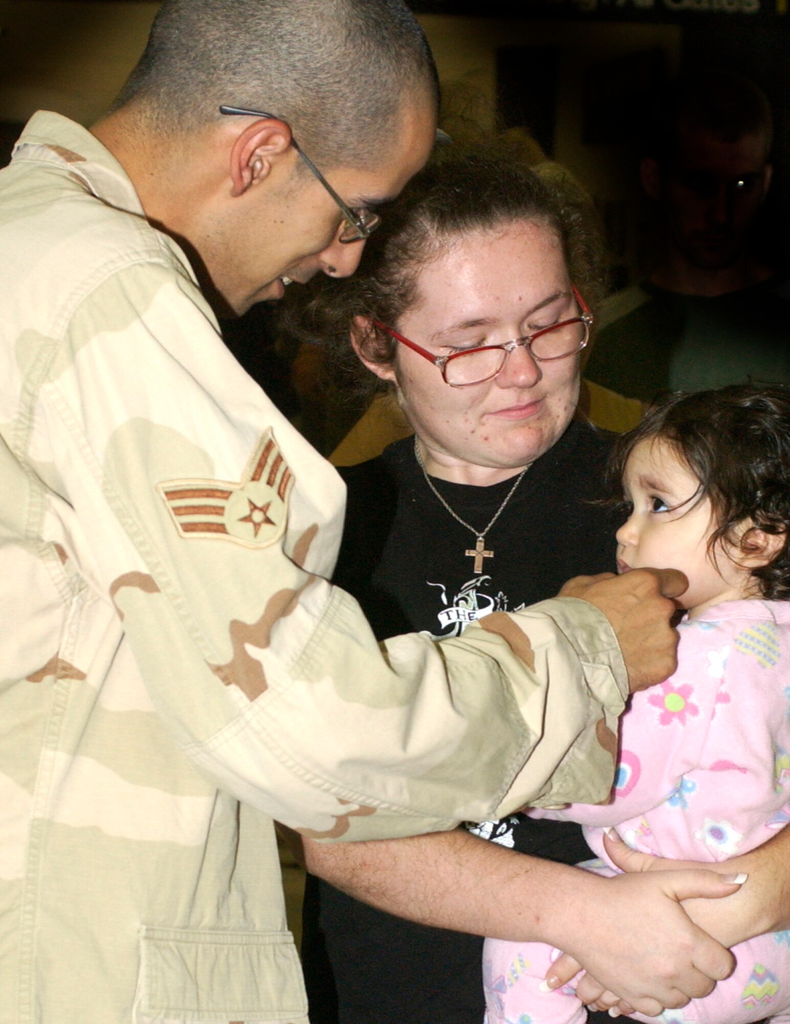 Senior Airmen Rudy Gonzales says hello to his 18-month-old daughter, Alexandria Gonzales, as her mother Crystal Chinn holds he. Airmen Gonzales was one of six team members from the 452nd Security Forces Squadron at March Air Reserve Base to return from a six month deployment to Kirkuk, Iraq on Sat., August 11, at the Los Angeles Airport.                               