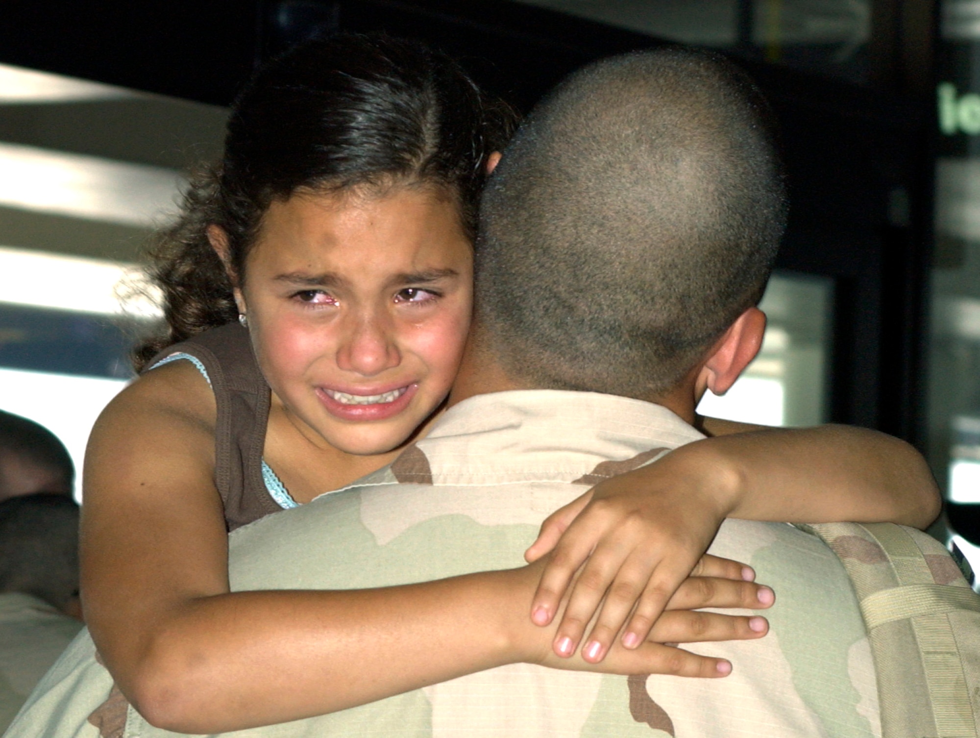Senior Airmen Raul Quinonez is greeted by his 10-year-old goddaughter Berenice Mejia at the Los Angeles Airport Sat., August 11. Airmen Quinonez was on of six team members from the 452nd Security Forces Squadron at March Air Reserve Base to return from a six month deployment to Kirkuk, Iraq.                               