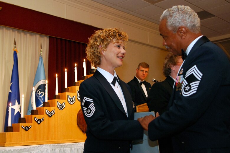HANSCOM AFB, Mass. -- Senior Master Sgt. Ginger Thompson, 66th Medical Group superintendent, is congratulated by retired Chief Master Sgt. Jim Francis during the Chief’s Recognition Ceremony. Sergeant Thompson will be promoted to the rank of chief master sergeant later this year. (U.S. Air Force photo by Mark Wyatt)
