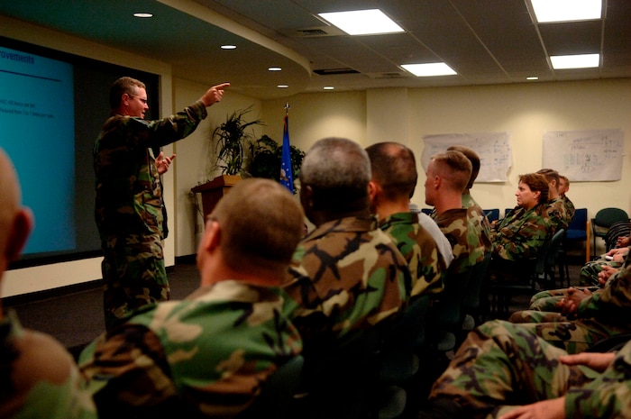 Master Sgt. William Huff, 437th Maintenance Squadron productions superintendent, briefs the maintenance group on how changes will be made during the outbrief after the lean event Aug. 10. (U.S. Air Force Photo/Airman 1st Class Nicholas Pilch)