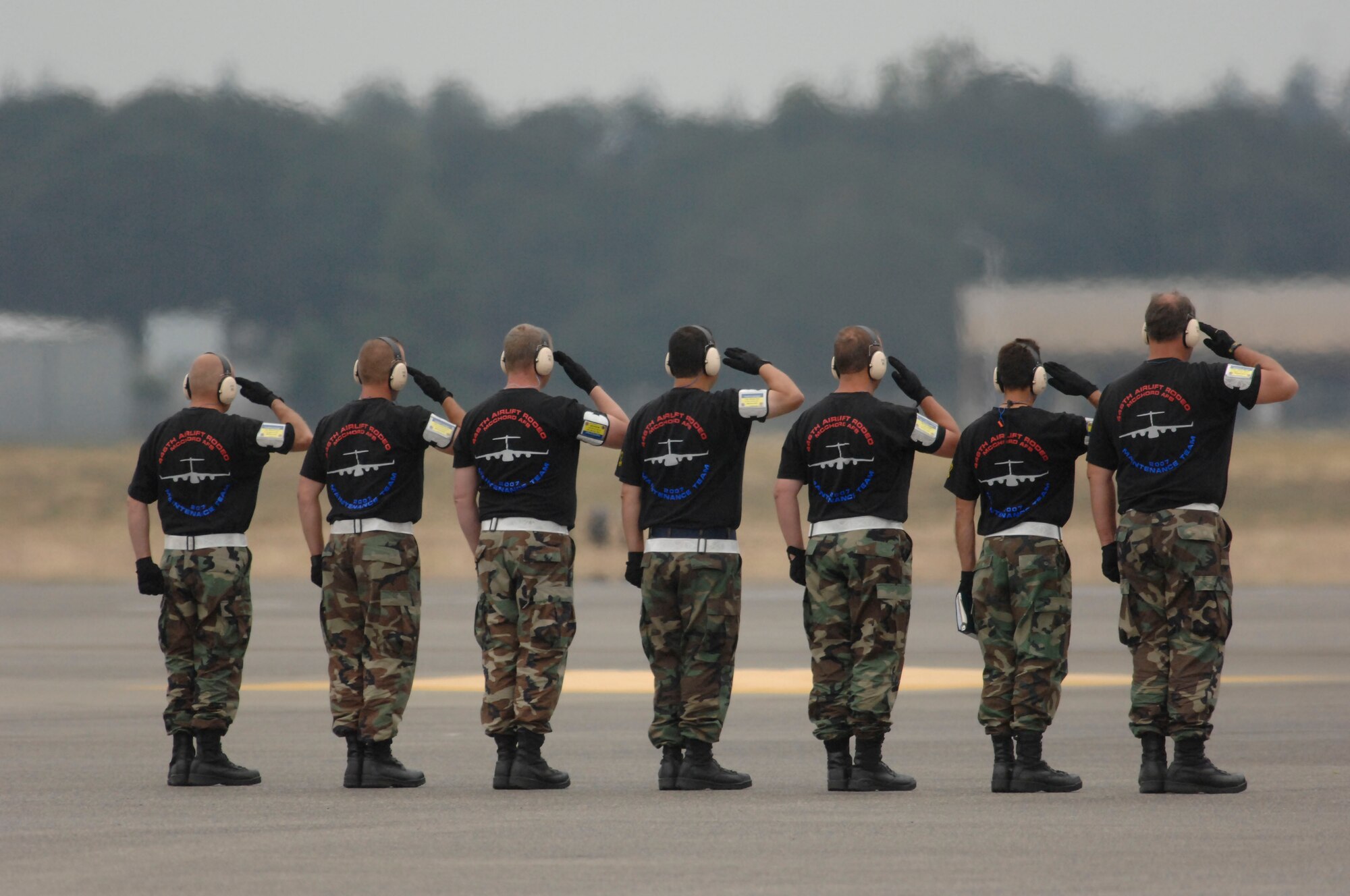 Seven Reservists on the 446th Airlift Wing's winning Rodeo maintenance team provide a send-off salute to the team's C-17 and its crew.  The McChord Air Force Base, Wash., Reserve wing's maintenance team won the Best C-17 Pre-flight award at Rodeo 2007, July 23-27 at McChord. (U.S. Air Force photo/Abner Guzman)