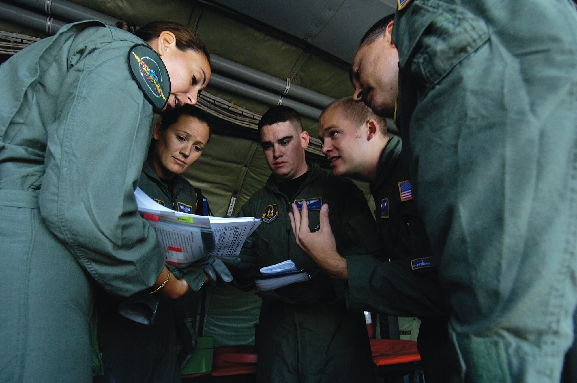 Maj. Esther Aubert (left to right), Tech. Sgt. Kristy Wellman, Senior Airman Larry Jones, Capt. Joe Foss, and Master Sgt. Dave Allen, all Reservists from the 446th Aeromedical Evacuation Squadron, McChord Air Force Base, Wash., discuss evacuation procedures at the aeromedical static configuration event during Air Mobility Command's Rodeo 2007, at McChord July 24. The event measured teams' abilities to perform aeromedical evacuations in a KC-135 and a C-17. AMC's Rodeo 2007 is a readiness competition of U.S. and international mobility air forces.  It focuses on improving war fighting capabilities and support of the Global War on Terrorism. (U. S. Air Force photo by Senior Airman Clay Lancaster) 