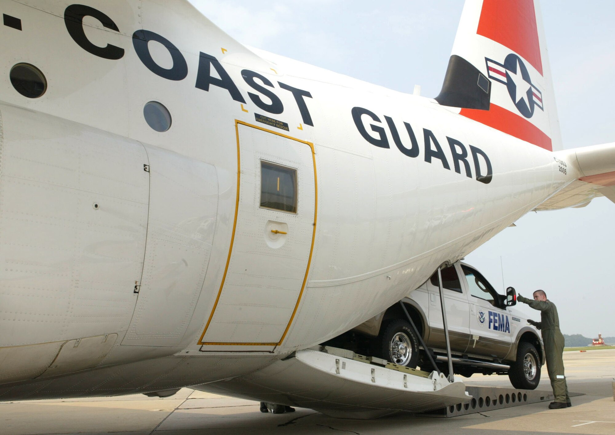 The transient aircraft ramp at Dobbins Air Reserve Base was home to a first-time partnership between the Coast Guard and a FIRST team. A Coast Guard C-130 crewmember loads a vehicle belonging to one of the Federal Emergency Management Agency's Federal Incident Response Support Team. The FIRST team is headed to Puerto Rico ahead of Atlantic storms. The teams are meant to support state and local response by expediting federal assistance and communication. The transport came from USGC Air Station at Elizabeth City, N.C. (U.S. Air Force photo/Don Peek)