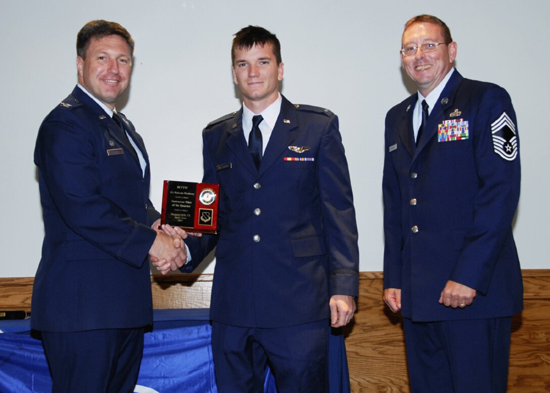 First Lt. Malcolm Westberry, 89th Flying Training Squadron, accepts the award for instructor pilot of the quarter at the 80th Flying Training Wing quarterly awards ceremony. (U.S. Air Force photo/Sandy Wassenmiller)