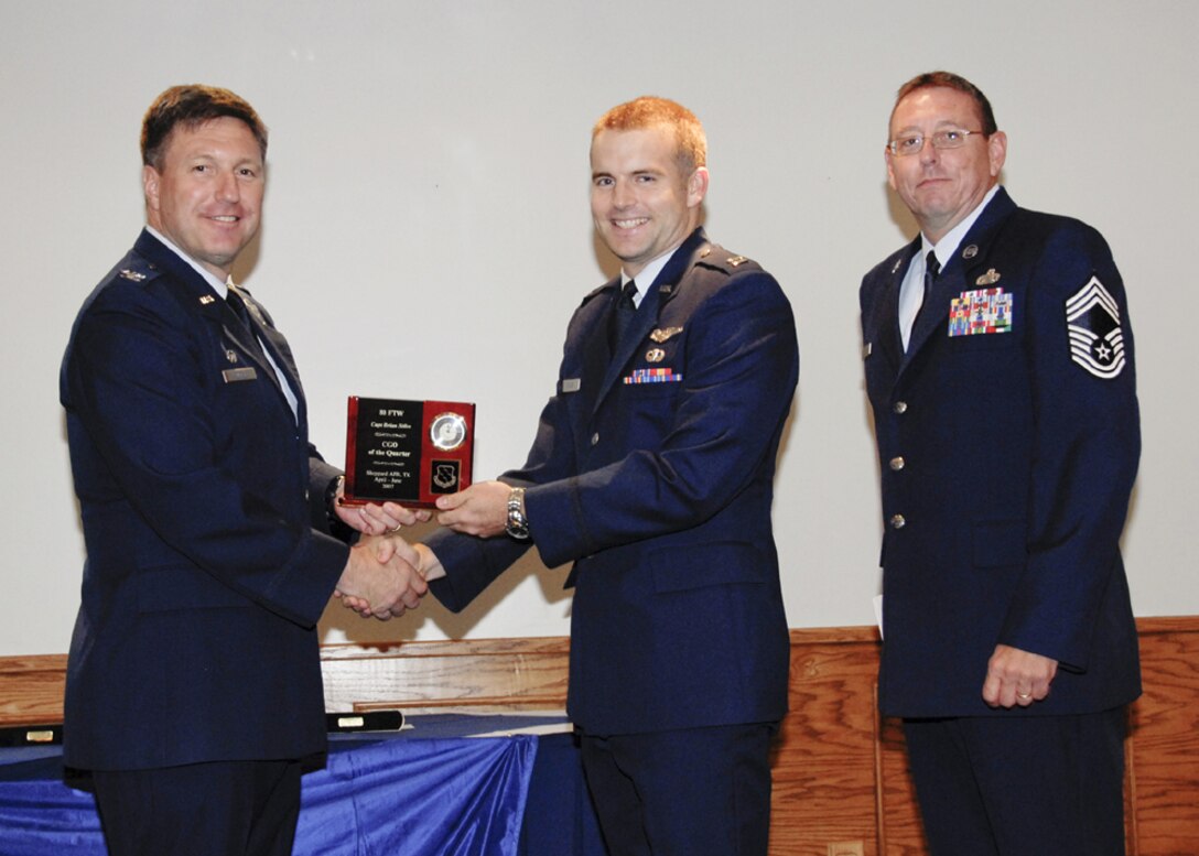 Capt. Brian Stiles, 90th Flying Training Squadron, accepts the award for company grade officer of the quarter at the 80th Flying Training Wing quarterly awards ceremony. (U.S. Air Force photo/Sandy Wassenmiller)