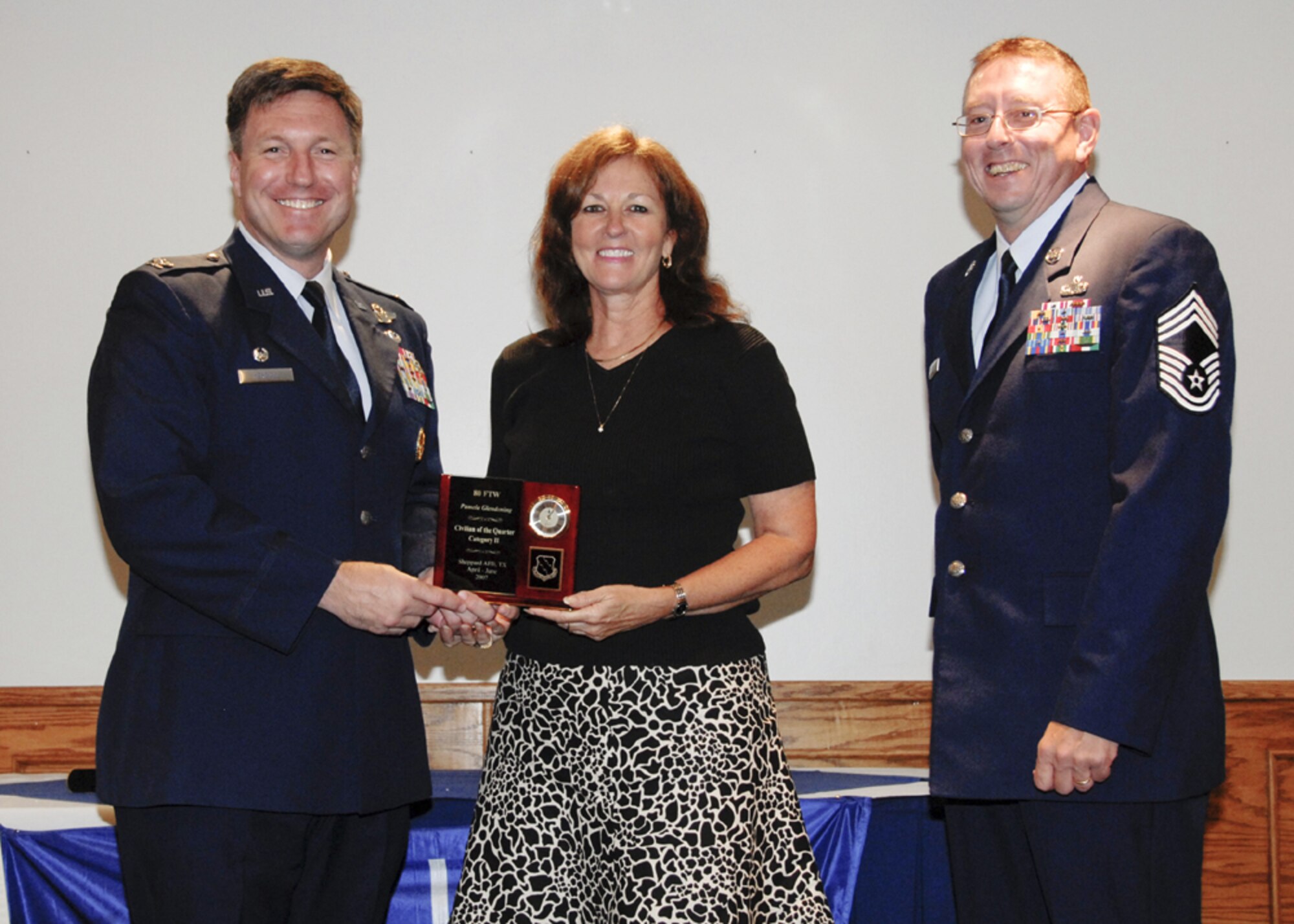 Ms. Pamela Glendening, 80th Operations Group, accepts the award for Civilian of the Quarter, category II, at the 80th Flying Training Wing quarterly awards ceremony. (U.S. Air Force photo/Sandy Wassenmiller)