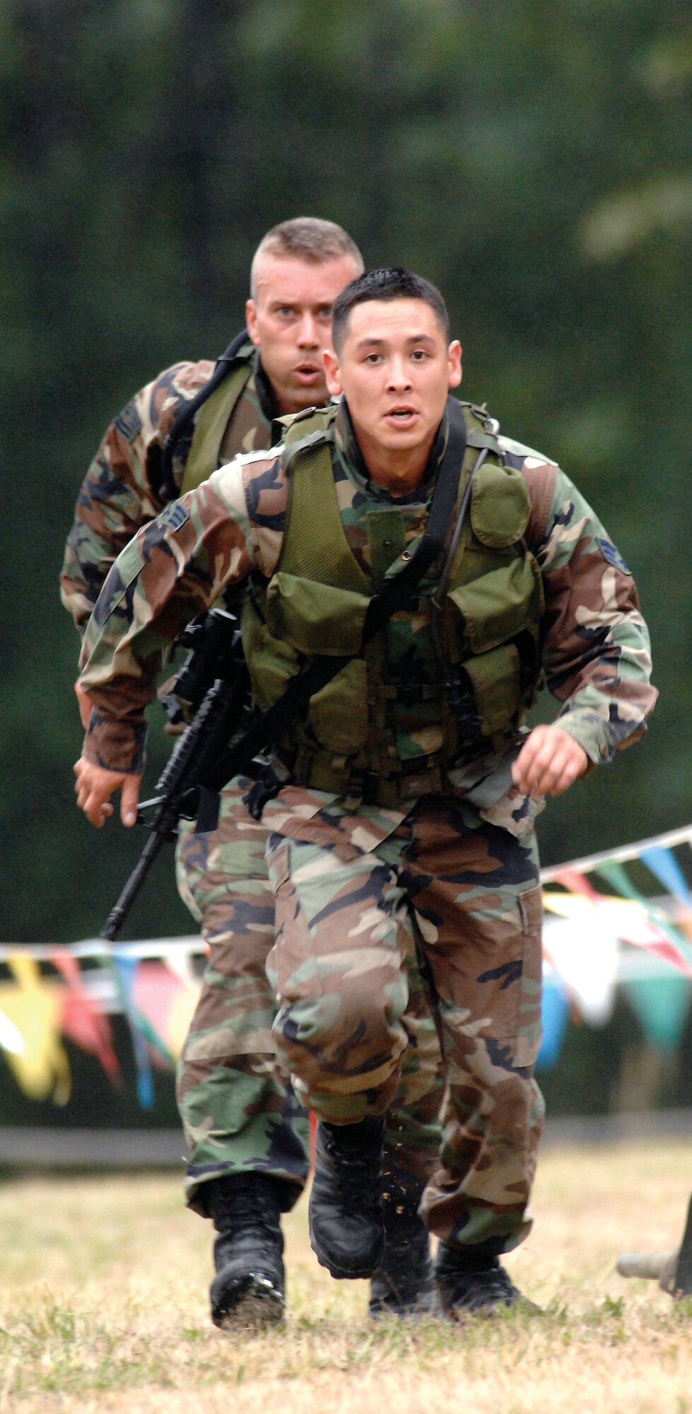 Senior Airman Giovanni Garcia leads the charge, followed closely by Tech. Sgt. Chris Pierce, during the combat challenge course at Rodeo 2007. Both Airmen are Reservists with the 446th Airlift Wing's security forces team, McChord Air Force Base, Wash.  (U.S. Air Force photo/Abner Guzman)