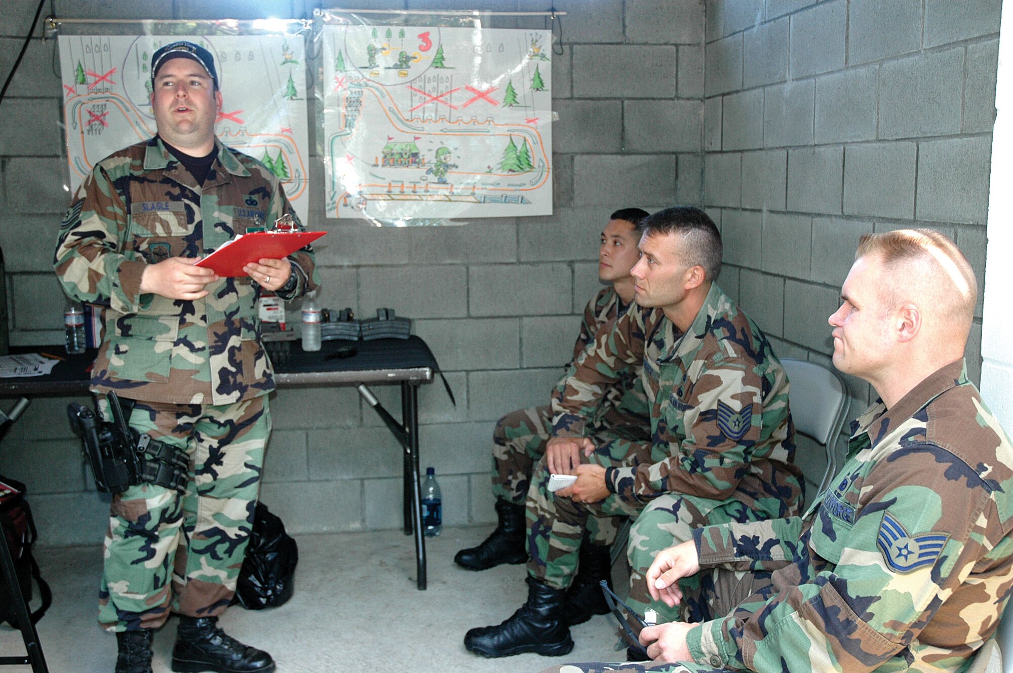 Tech. Sgt. Robert Slagle, 62nd Security Forces Squadron, McChord Air Force Base, Wash., briefs the Reserve's 446th Airlift Wing security forces Rodeo team about the route and rules of the weapons tactics course at Rodeo 2007.  The 446th AW is an Air Force Reserve Associate unit at McChord.  (U.S. Air Force photo/Sandra Pishner)