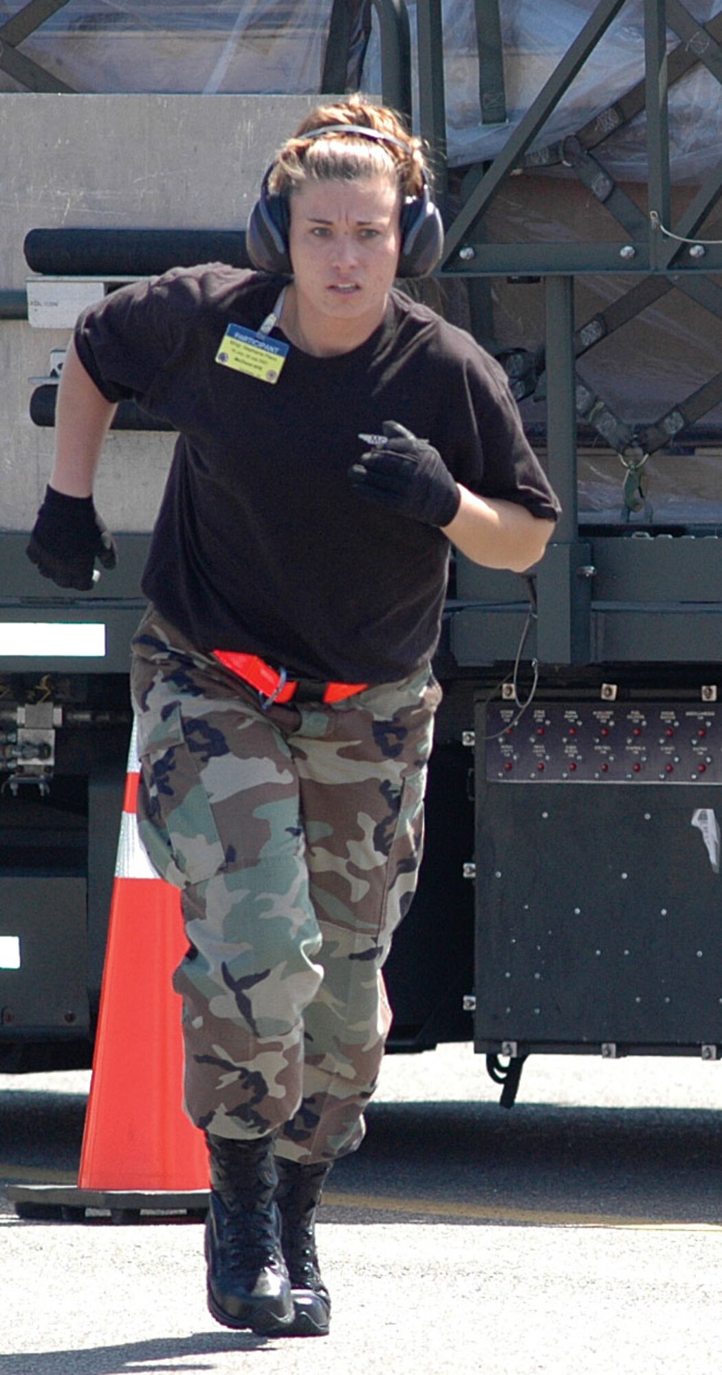 Reservist Master Sgt. Stephanie Place, 446th Airlift Wing aerial port team, McChord Air Force Base, Wash., runs into position to provide direction for the 25K Halvorsen driving challenge during Rodeo 2007 here. (U.S. Air Force photo/Sandra Pishner)