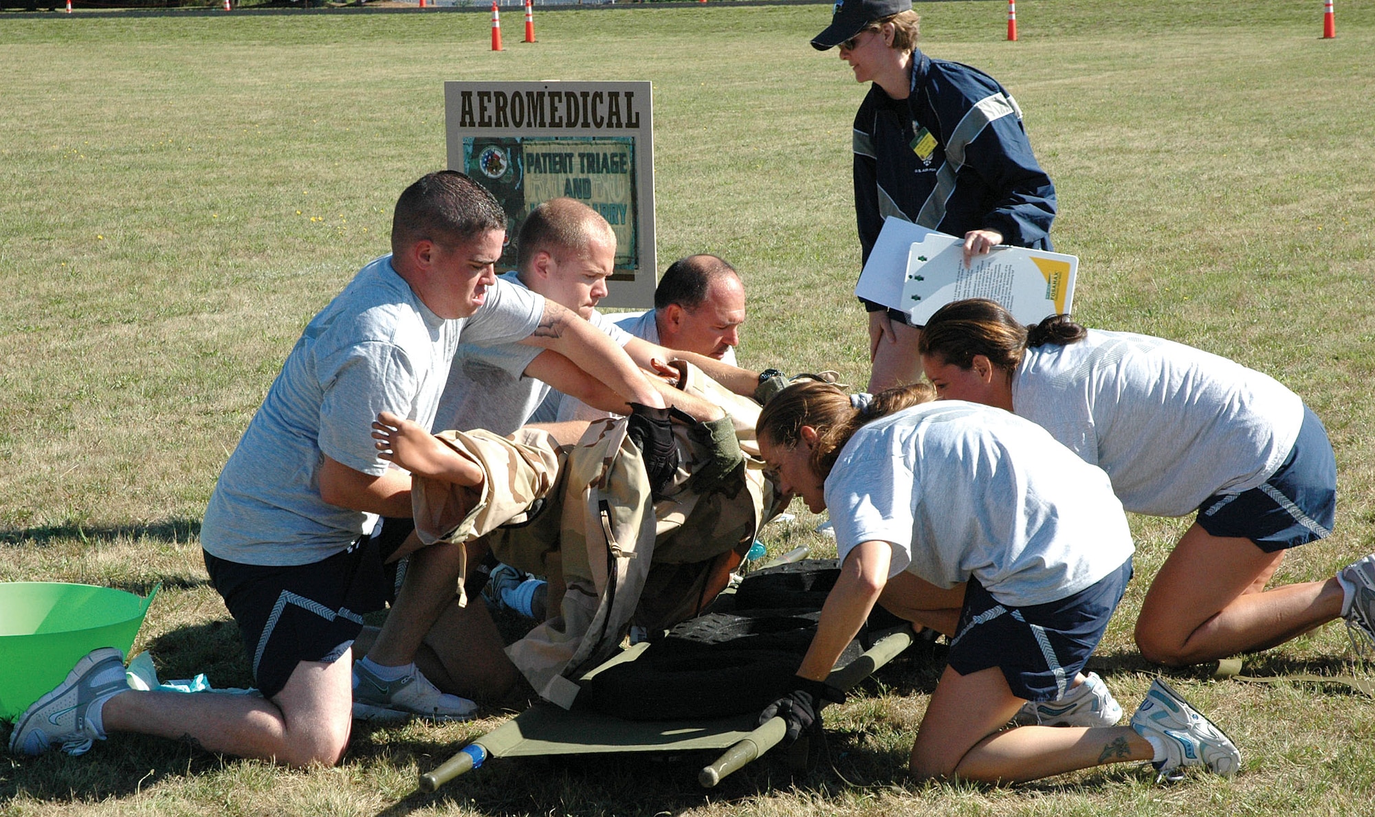 The 446th Aeromedical Evacuation Squadron team moves a mock patieent from the ground to a litter before carryign him through an obstacle course during the AE challenge course at the Rodeo 2007 competition at McChord Air Force Base, Wash., July 23-27. The team wone the Aune Paget Trophy for best aeromedical team and also won the best aeromedical contingency flight award. (U.S. Air Force photo/Capt. Jennifer Gerhardt)