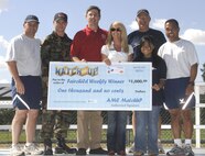FAIRCHILD AIR FORCE BASE, Wash. – (Front right) Jmie Godoy, 13, and her father, Master Sgt. Lusito Godoy of the 92nd Logistics Readiness Squadron, display Jmie’s $1,000 MatchUP check with other Fairchild members Aug. 10. The Air Mobility Command online game is open to all family members and base employees, as well as active-duty members. Jmie said winning the prize was “shocking,” and that she plans to save her money. More Fairchild MatchUP prizes will be awarded through the end of the month; the game ends Aug. 31. (U.S. Air Force photo / Senior Airman Chad Watkins)