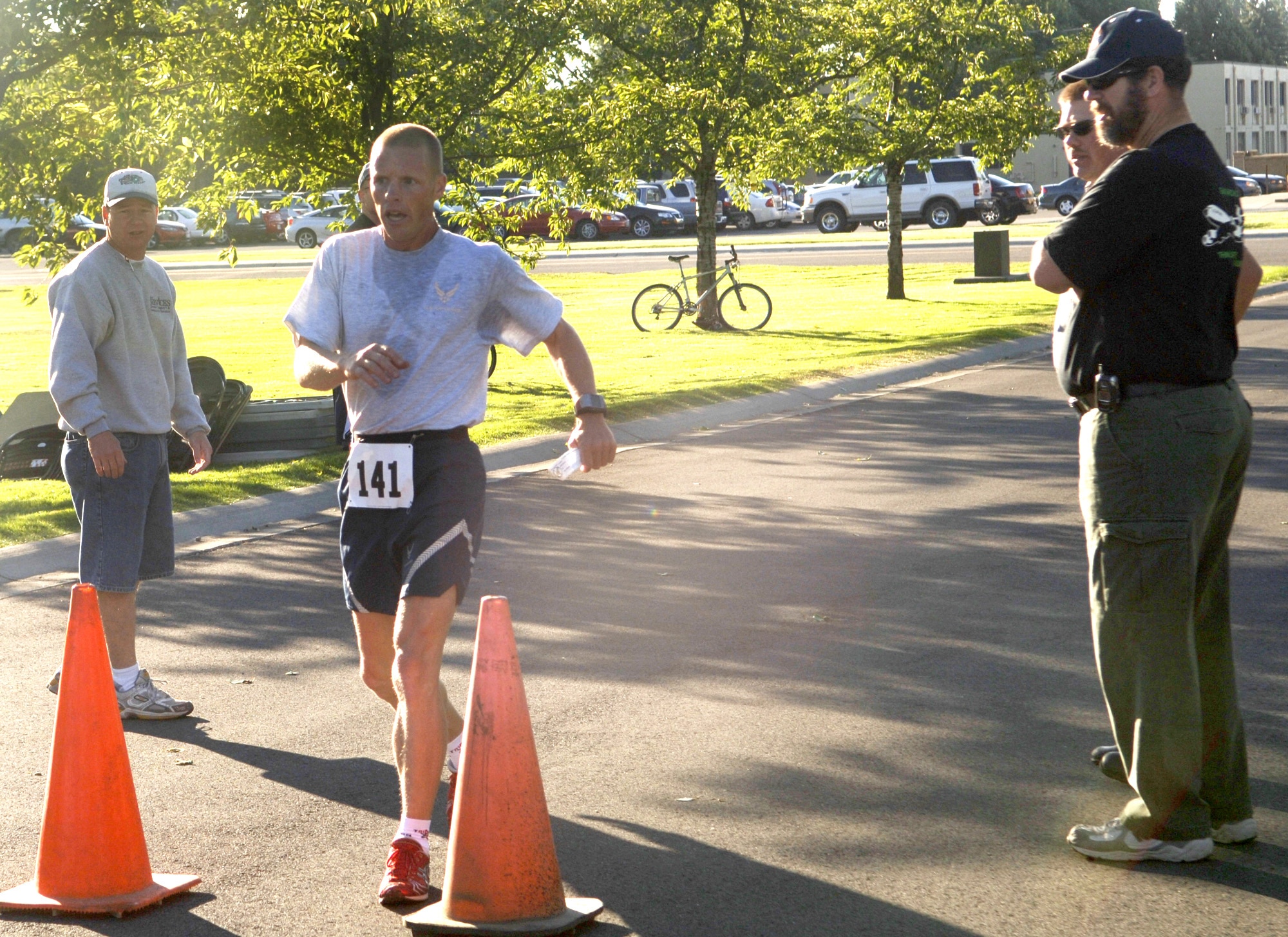 FAIRCHILD AIR FORCE BASE, Wash. -- Tech. Sgt. Michael Bergquist, Washington Air National Guardsman activated to the 92nd Security Forces Squadron here, crosses the finish line first during a base-wide 5k run Aug. 10, which took place during the post-Unit Compliance Inspection Commander’s Sports Challenge. Sergeant Bergquist is a triathlon sprint specialist and will represent the Air Force on the all Military Team USA competing in the 4th annual Military World Games in India in October. (U.S. Air Force Photo / Senior Airman Chad Watkins)