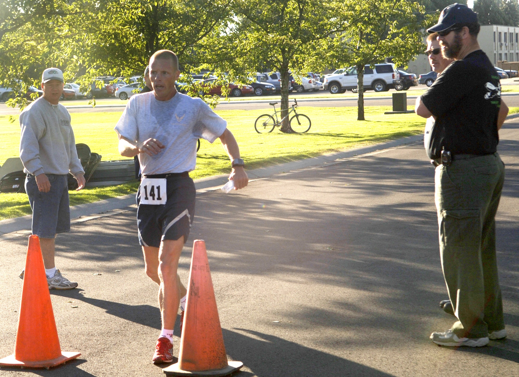 FAIRCHILD AIR FORCE BASE, Wash. -- Tech. Sgt. Michael Bergquist, Washington Air National Guardsman activated to the 92nd Security Forces Squadron here, crosses the finish line first during a base-wide 5k run Aug. 10, which took place during the post-Unit Compliance Inspection Commander’s Sports Challenge. Sergeant Bergquist is a triathlon sprint specialist and will represent the Air Force on the all Military Team USA competing in the 4th annual Military World Games in India in October. (U.S. Air Force Photo / Senior Airman Chad Watkins)