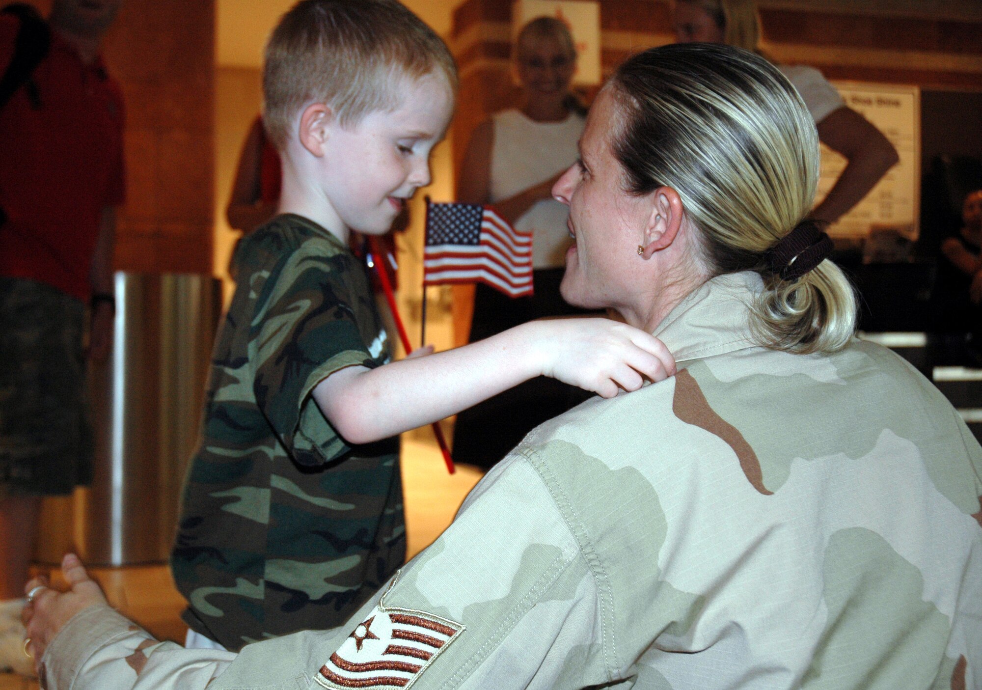 Tech. Sgt. Erin Buchanan hugs her son, Kyle, at the airport after returning home Aug. 15 from a deployment in Iraq. Sergeant Buchanan, a life support specialist, was assigned to the 332nd Expeditionary Fighter Squadron and volunteered in the hospital's emergency room trauma section, loaded patients and even crewed airplanes. Sergeant Buchanan, who had been deployed since June 22, is a reservist assigned to the 944th Fighter Wing at Luke Air Force Base, Ariz. (U.S. Air Force photo/Tech. Sgt. Susan Stout)