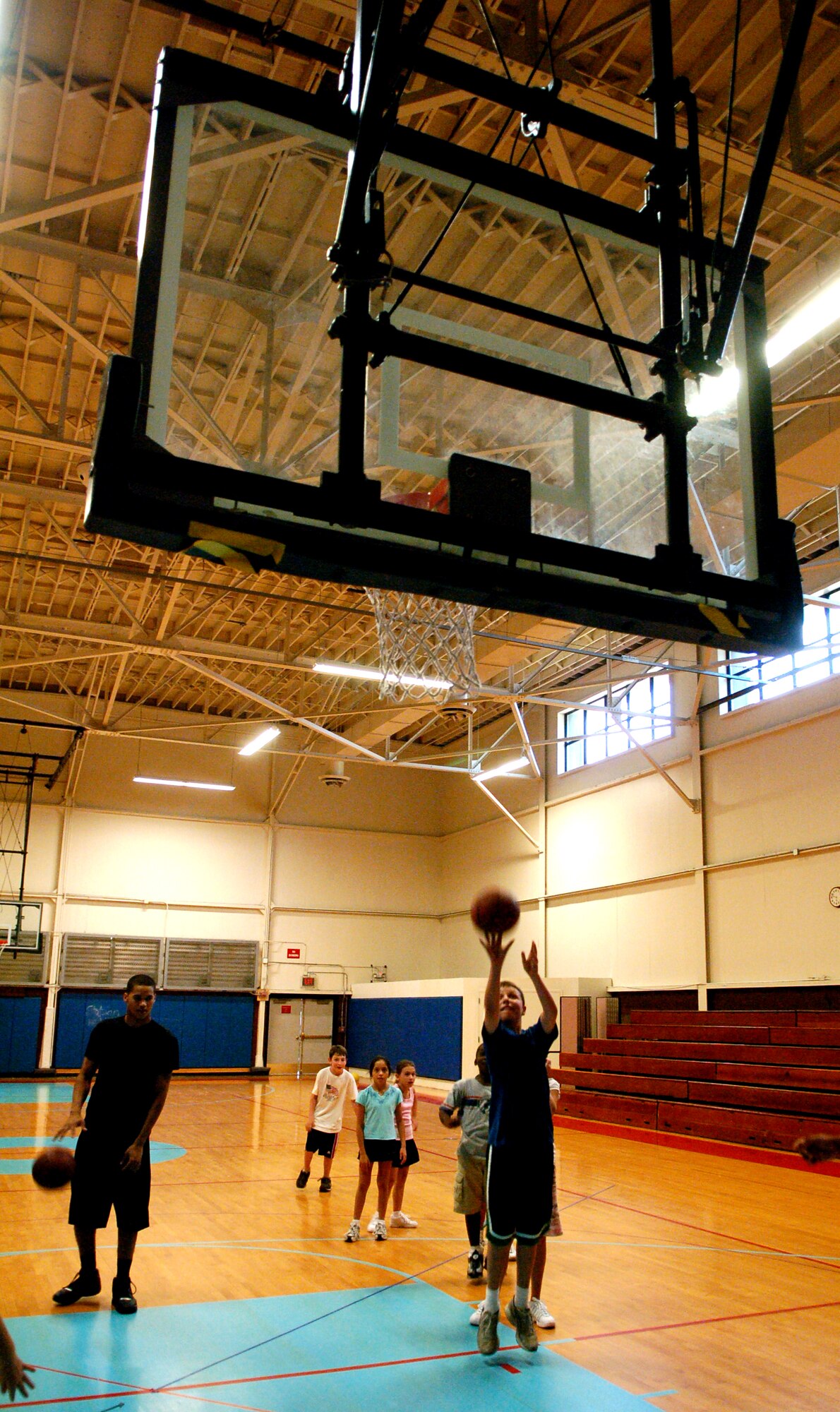 LAUGHLIN AIR FORCE BASE, Texas – Bowe Brust, son of Maj. Robert Brust, 87th Flying Training Squadron, and Colleen Brust, attempts a shot while Assistant Coach Airman 1st Class Luke Smith, 47th Operations Support Squadron, looks on.  Bowe attended a basketball camp put on by the Laughlin Youth Center.  (U.S. Air Force photo by Staff Sgt. Austin M. May)