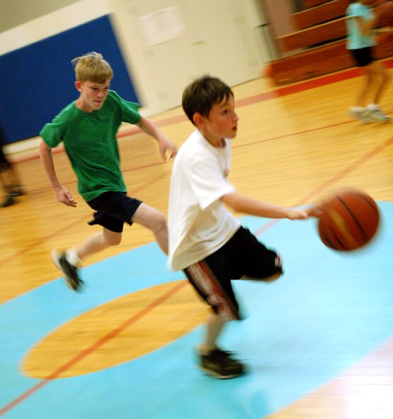 LAUGHLIN AIR FORCE BASE, Texas – Alex Bowes, son of Lt. Col. John Bowes, 96th Flying Training Squadron, and Peggy Bowes, tries to out dribble Jeremy Pace, son of Jeff Heisler, 47th Mission Support Group.  The boys attended a basketball camp put on by the Laughlin Youth Center.  (U.S. Air Force photo by Staff Sgt. Austin M. May)