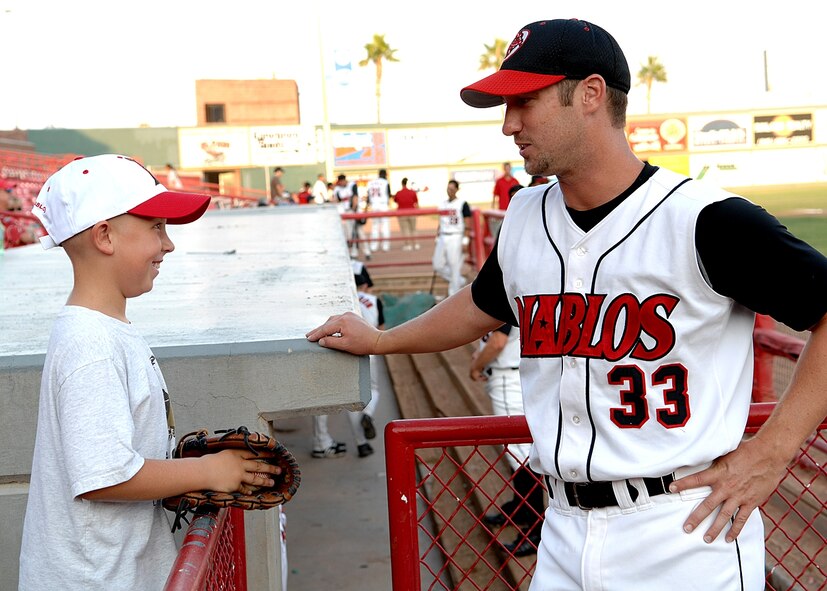 Josh Neitz, El Paso Diablo, talks with a fan before the game. The Diablos held a military appreciation night Aug. 15. (U.S. Air Force photo/Airman 1st Class John Strong)