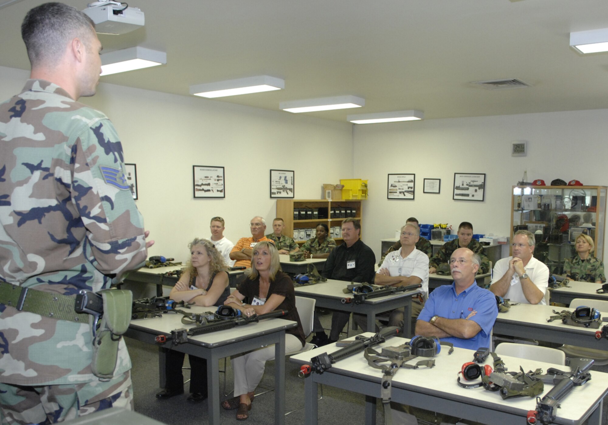 Vance honorary commanders receiving weapons training to prepare to deploy to the fictional country of Tarzanistan.  Eight Vance honorary commanders visited the base Tuesday for an insider’s look at the 71st Mission Support Group’s operations. The group was exposed to the deployment mission because Vance has many Airmen deployed or about to deploy. (Air Force photo by Terry Wasson)
