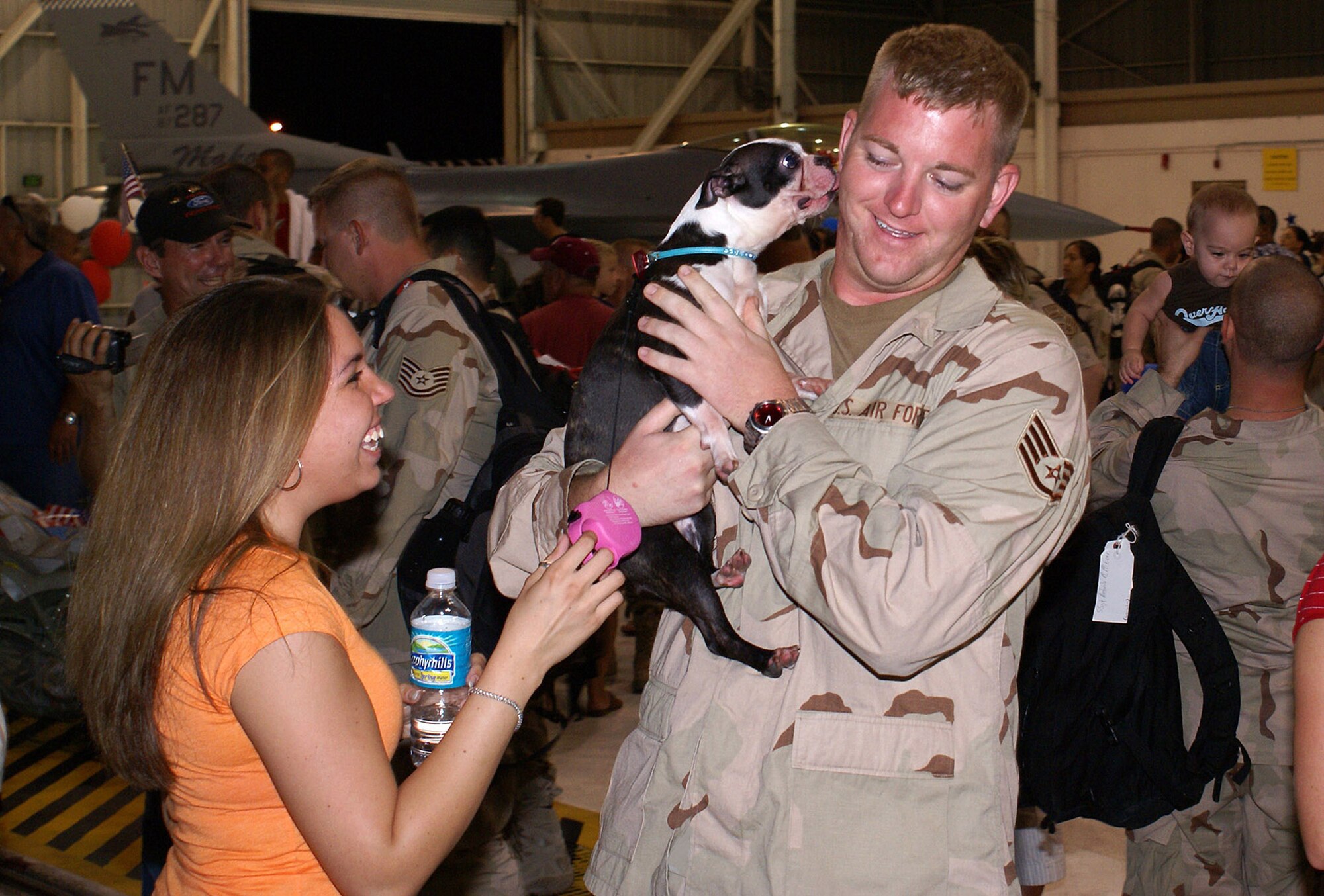 Staff Sgt. Theodore Yoder is greeted by Roxy, his Boston Terrier, and Senior Airman Kristi Ayala-Rosado Aug. 13 at Homstead Air Reserve Base, Fla. More than 260 Airmen from Homestead ARB were welcomed home as they returned from a deployment to Balad Air Base, Iraq. Sergeant Yoder is a 482nd Maintenance Squadron crew chief, and Airman Ayala-Rosado is assigned to the 482nd Security Forces Squadron. Members of the 93rd Fighter Squadron from the 482nd Fighter Wing at Homestead ARB provided close-air support and surveillance and reconnaissance missions in support of U.S. and coalition ground forces. (U.S. Air Force photo/Senior Airman Erik Hofmeyer)