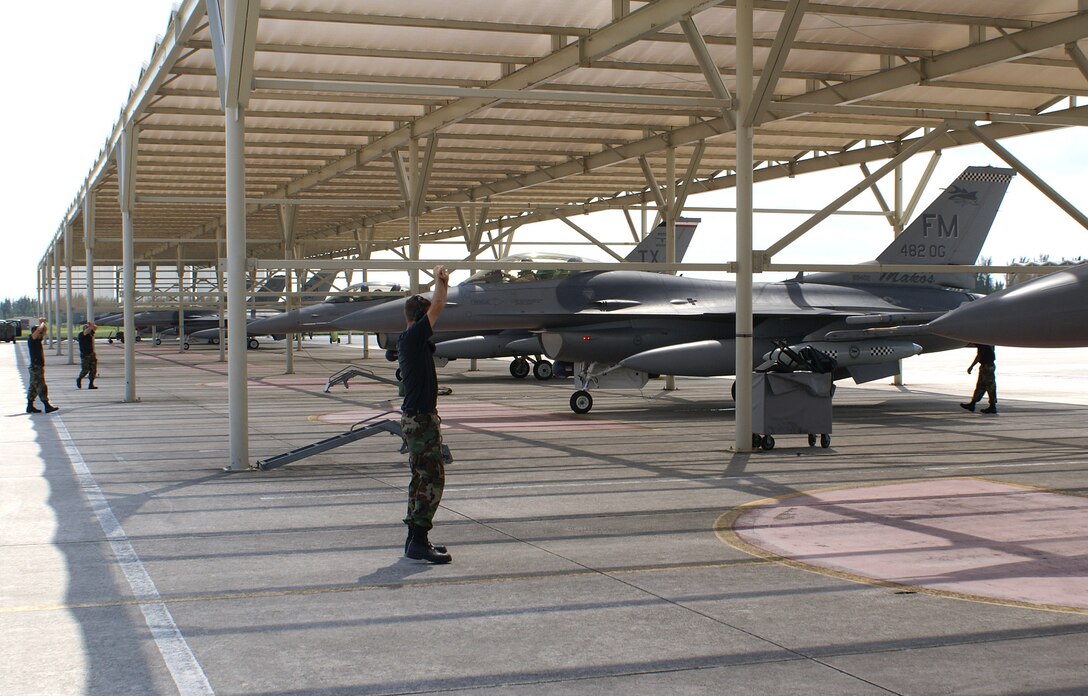 482nd Fighter Wing F-16s are marshaled into the sun shades by 482nd Aircraft Maintenance Squadron crew chiefs Wednesday upon arrival from a deployment to Balad Air Base, Iraq. The aircraft were part of 12 F-16s and over 260 Airmen deployed in support of Operation Iraqi Freedom. The reservists provided close air support and surveillance and reconnaissance missions in support of U.S. and Coalition ground forces. (U.S. Air Force photo/Senior Airman Erik Hofmeyer)