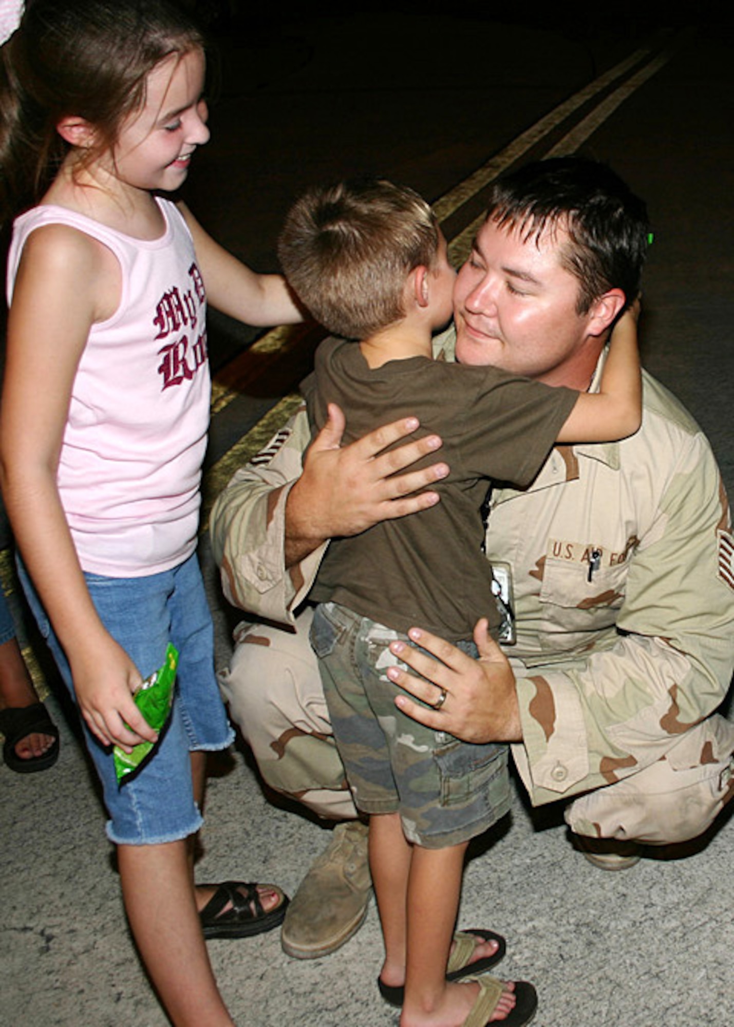 Tech. Sgt. Josh Bateman is greeted by his son Mason, 5, and his daughter Madison, 9 at Sgt. Bateman’s homecoming from Iraq Mon., Aug. 13. Sgt. Bateman had just returned as a member of an AEF contingent that deployed from Homestead Air Reserve Base. (U.S. Air Force photo/Senior Master Sgt. Ray Sarracino)