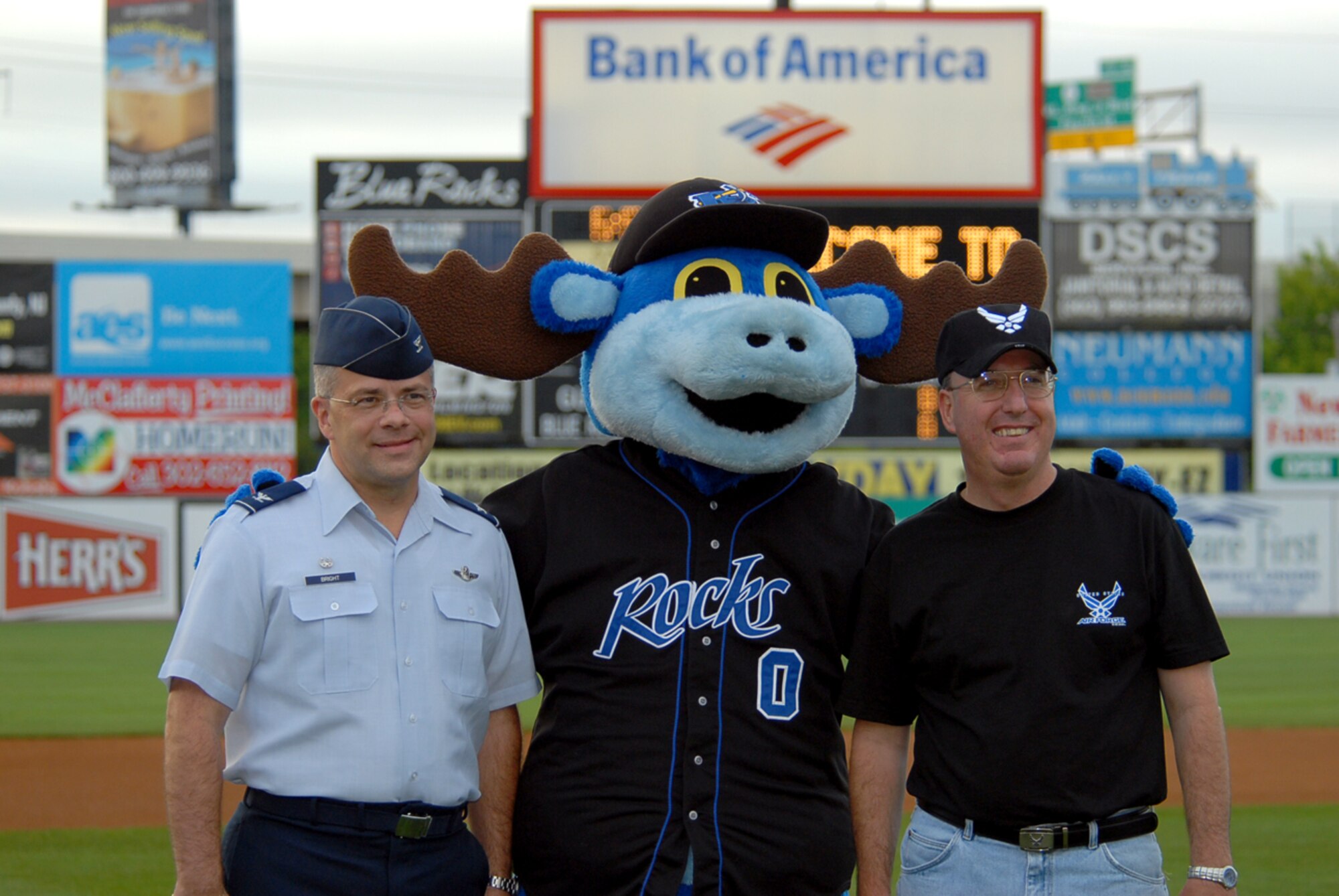 Col. Randal Bright, 512th Airlift Wing commander, Rocky, Wilmington Blue Rocks' mascott, and Chief Master Sgt. Bruce Blodgett, 436th AW command chief are honored in an opening ceremony at the Blue Rocks' game Aug. 10. (U.S. Air Force photo/ Tech. Sgt. Kevin Wallace)