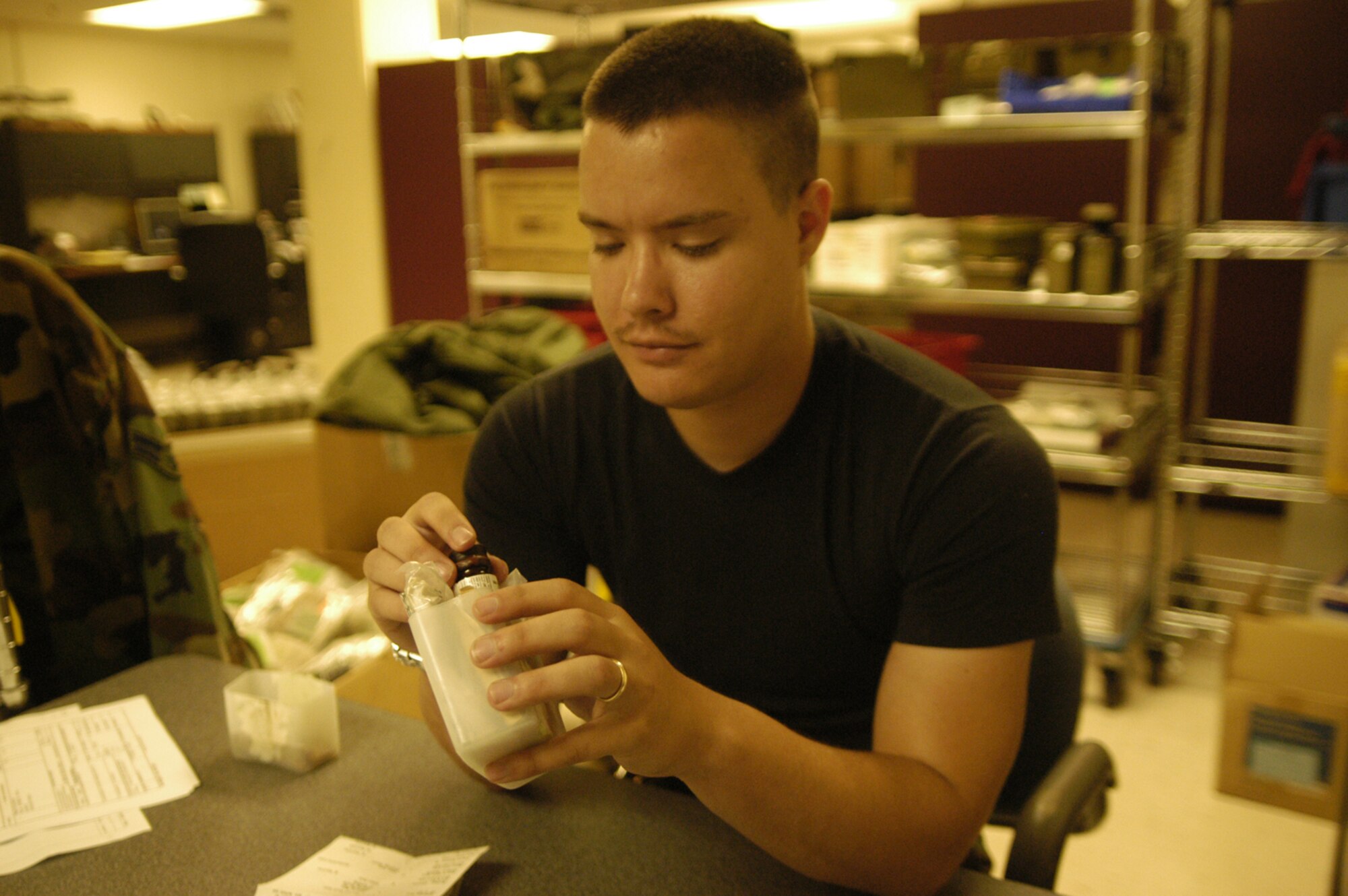 (Airman 1st Class Timothy Barnhart, 436th Medical Support Squadron medical logistics material journeyman, inspects first aid kits to ensure they are not outdated and to add or remove contents. Many items can be included in first aid kits. Water, bandages, alcohol wipes, and gauze are included in nearly all kits. Additionally, matches and even candy or soup may be housed in kits for those Airmen at deployed locations overseas. (U.S. Air Force photo/Airman Shen-Chia Chu)